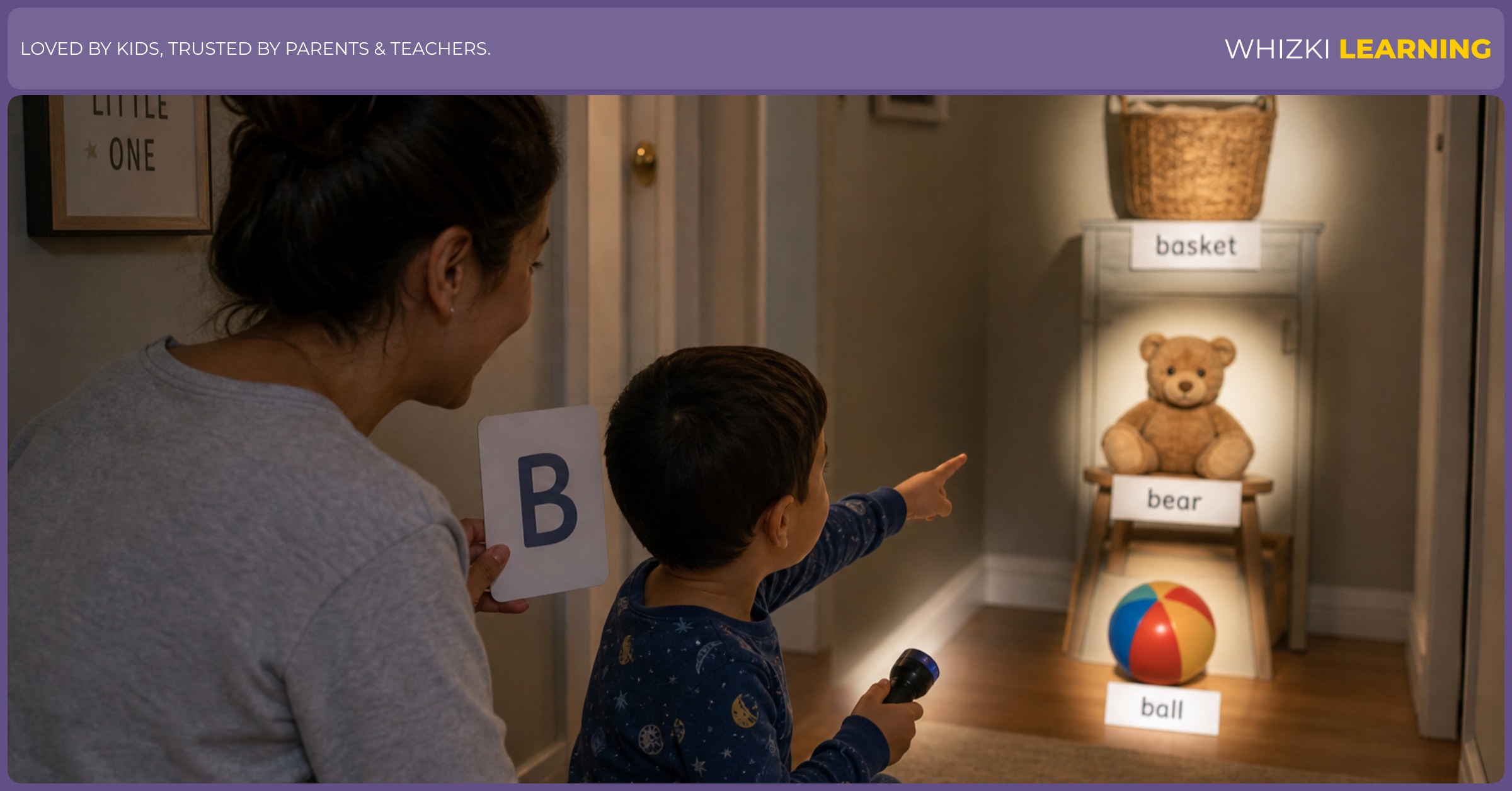 Parent and child play a calm flashlight game at bedtime, searching for objects that start with B while the adult holds letter cards turned toward the child