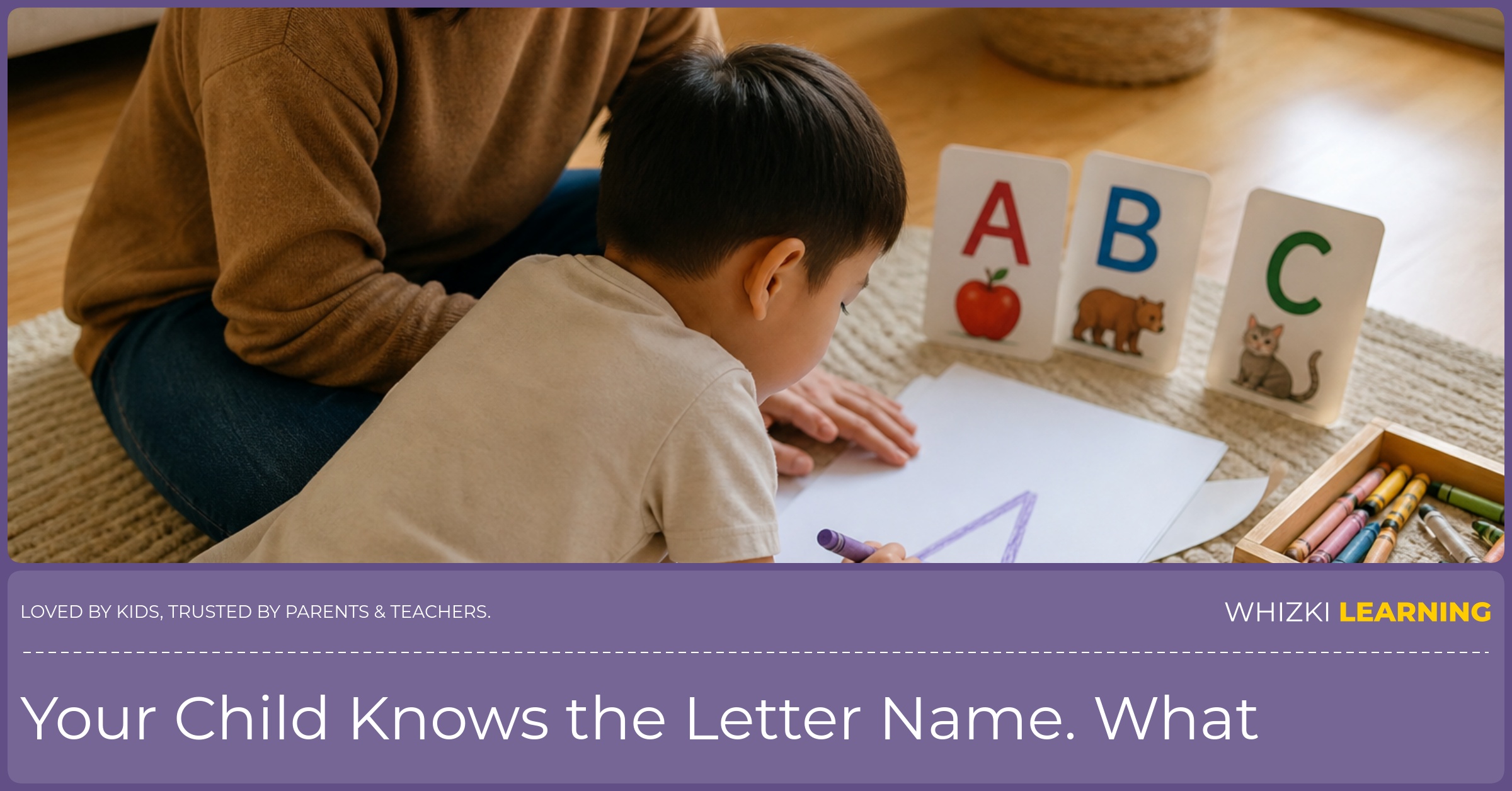 A caregiver sits beside a child using a chunky crayon to make a large letter on paper in the living room.