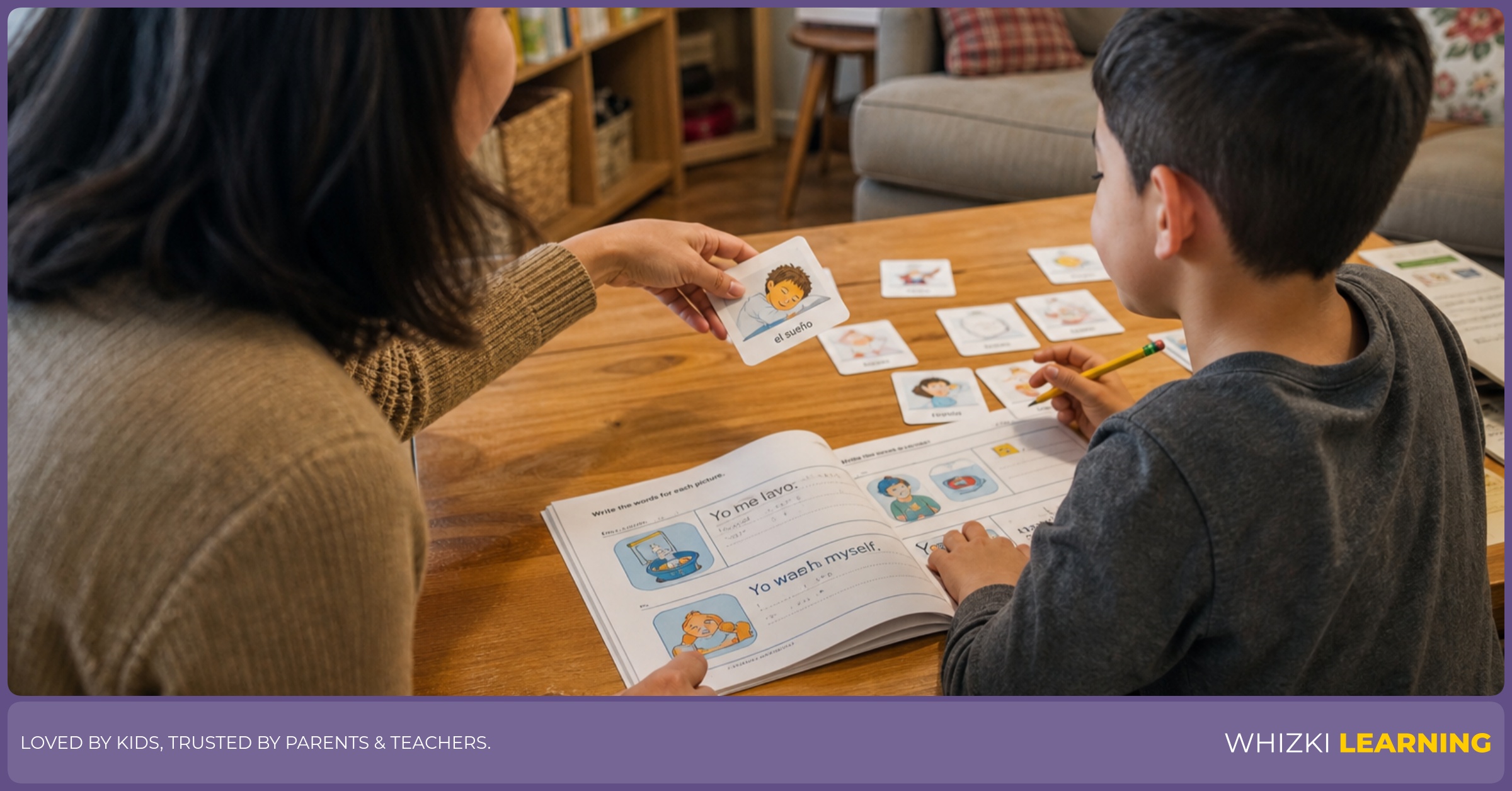 A caregiver helps a child sort picture cards beside a bilingual workbook page while a pencil rests nearby.