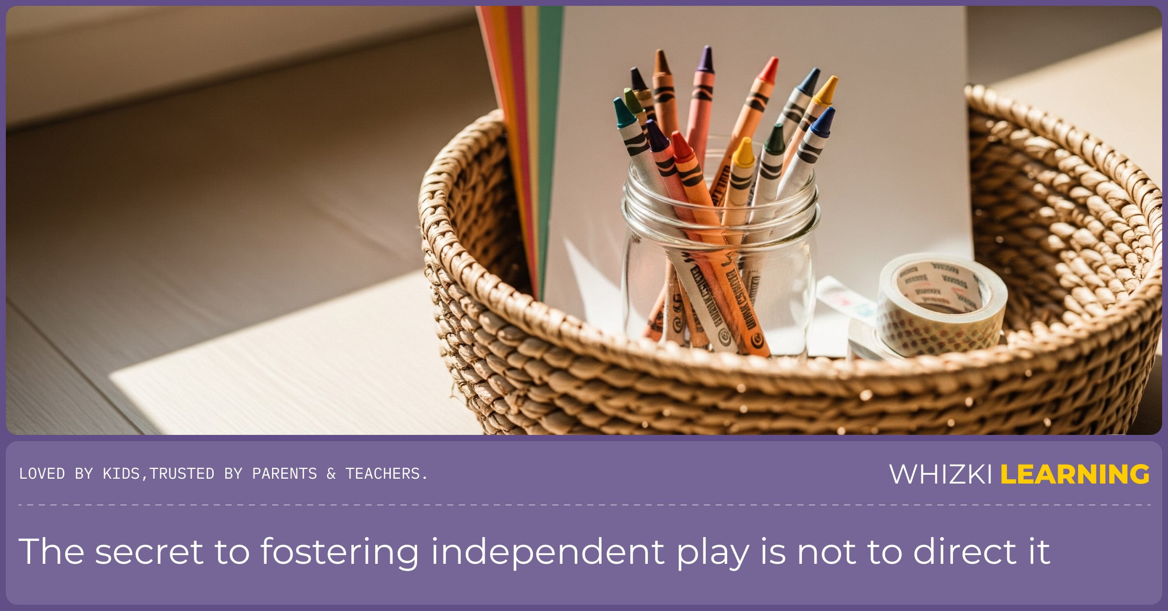 A simple basket on a wooden floor, filled with art supplies like paper and crayons.