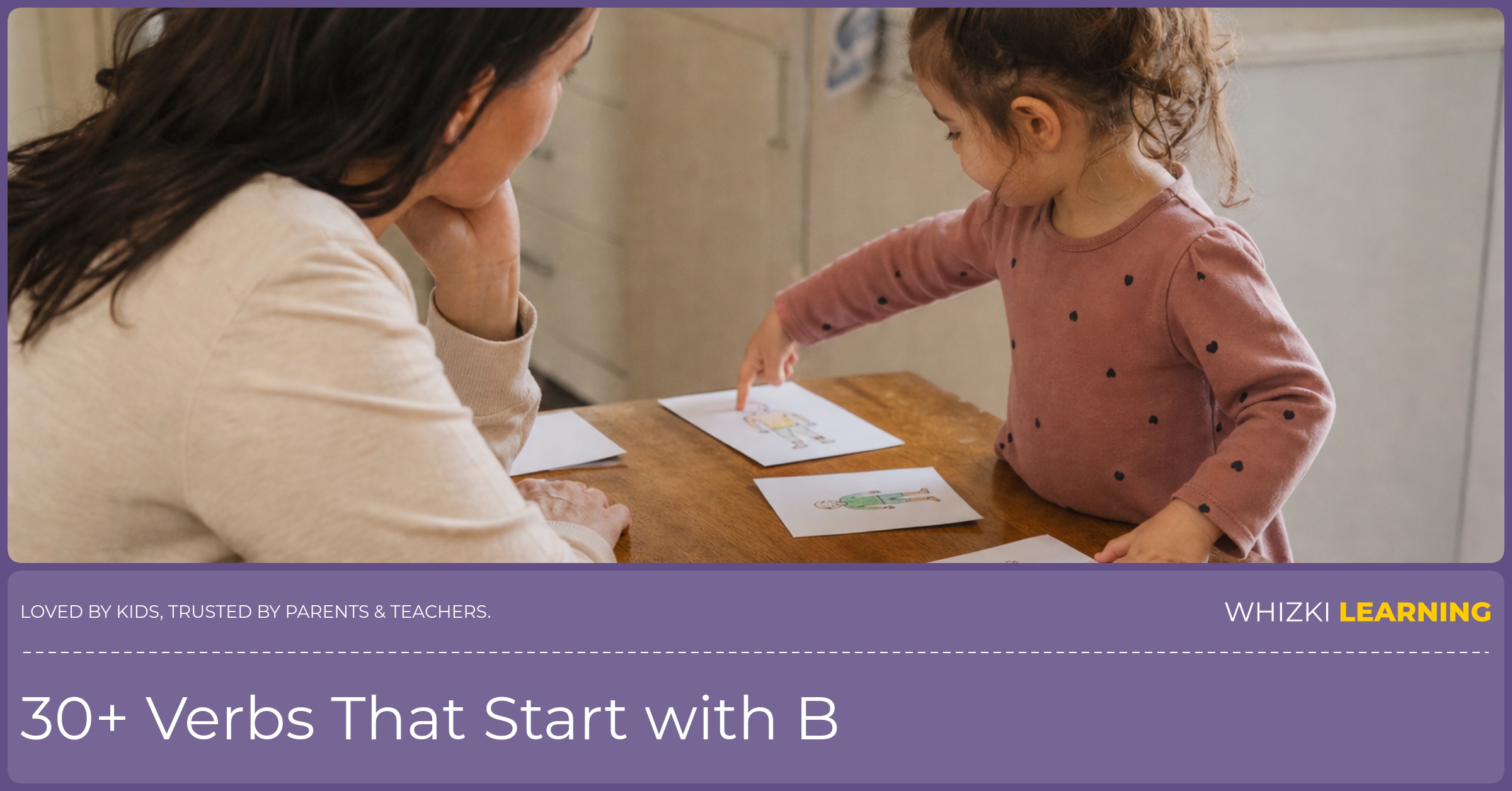 A parent sits beside a child who is acting out B verbs with printed cards on a warm kitchen table.