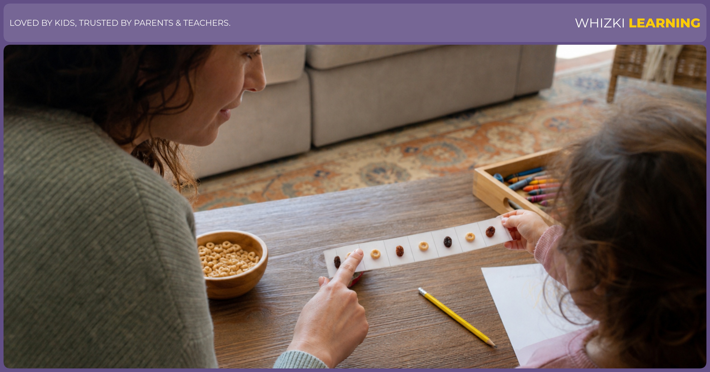 A child uses a paper pattern strip and snack pieces while a parent watches and points beside the page.