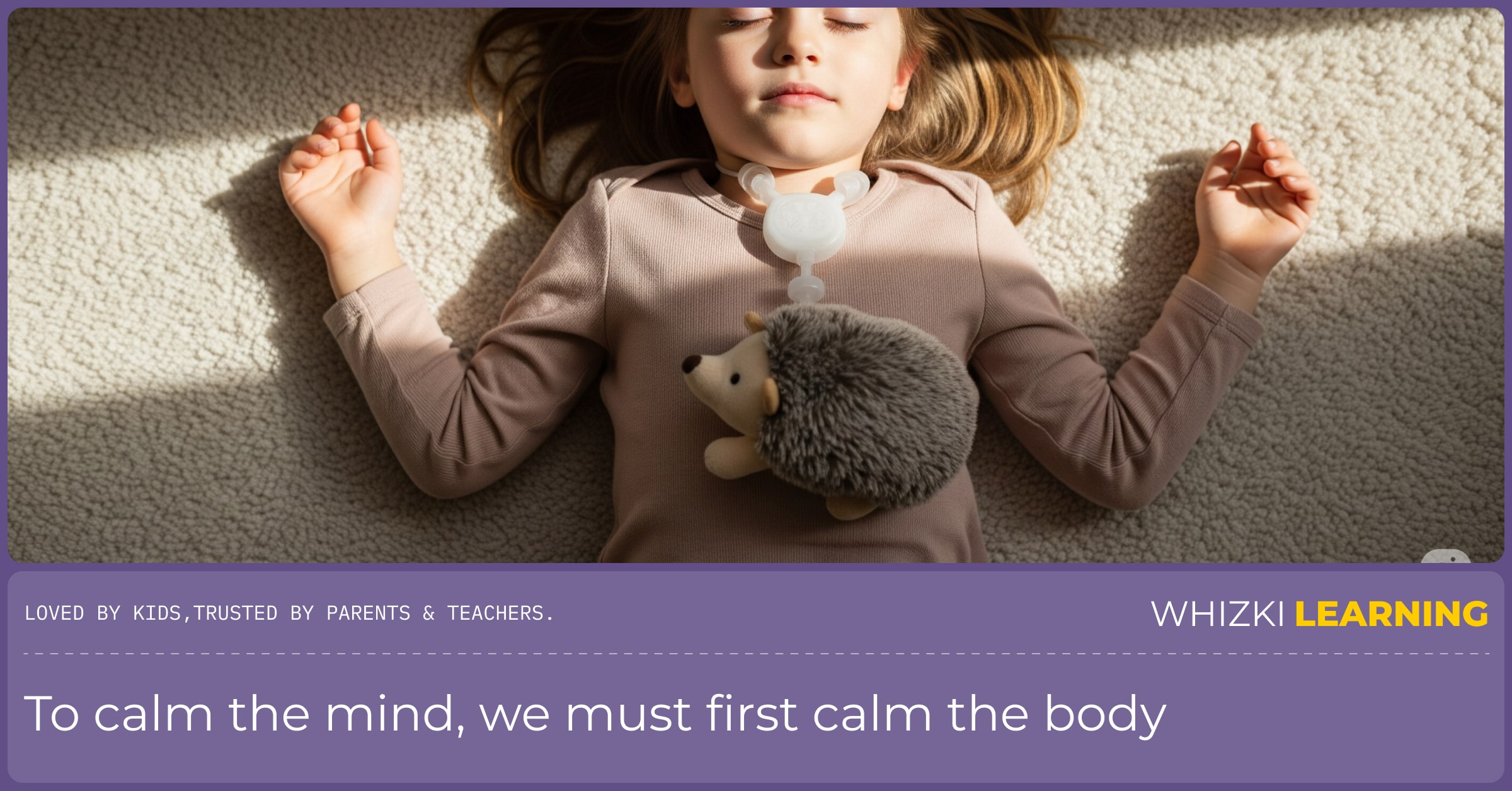 A top-down view of a child lying peacefully on the floor with a small stuffed hedgehog on their stomach.