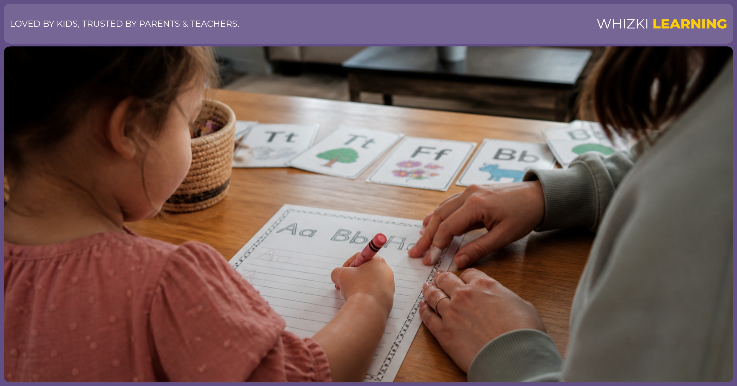 A caregiver watches a child use a crayon in a large writing space on a printed practice page.