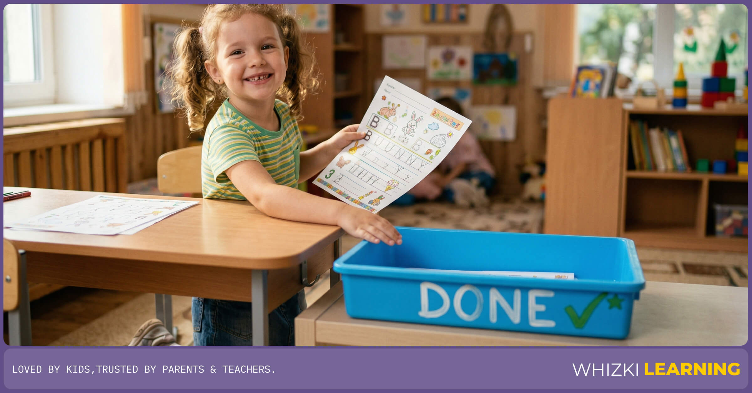 A smiling child putting a completed educational worksheet into a designated completion basket on a home learning desk.