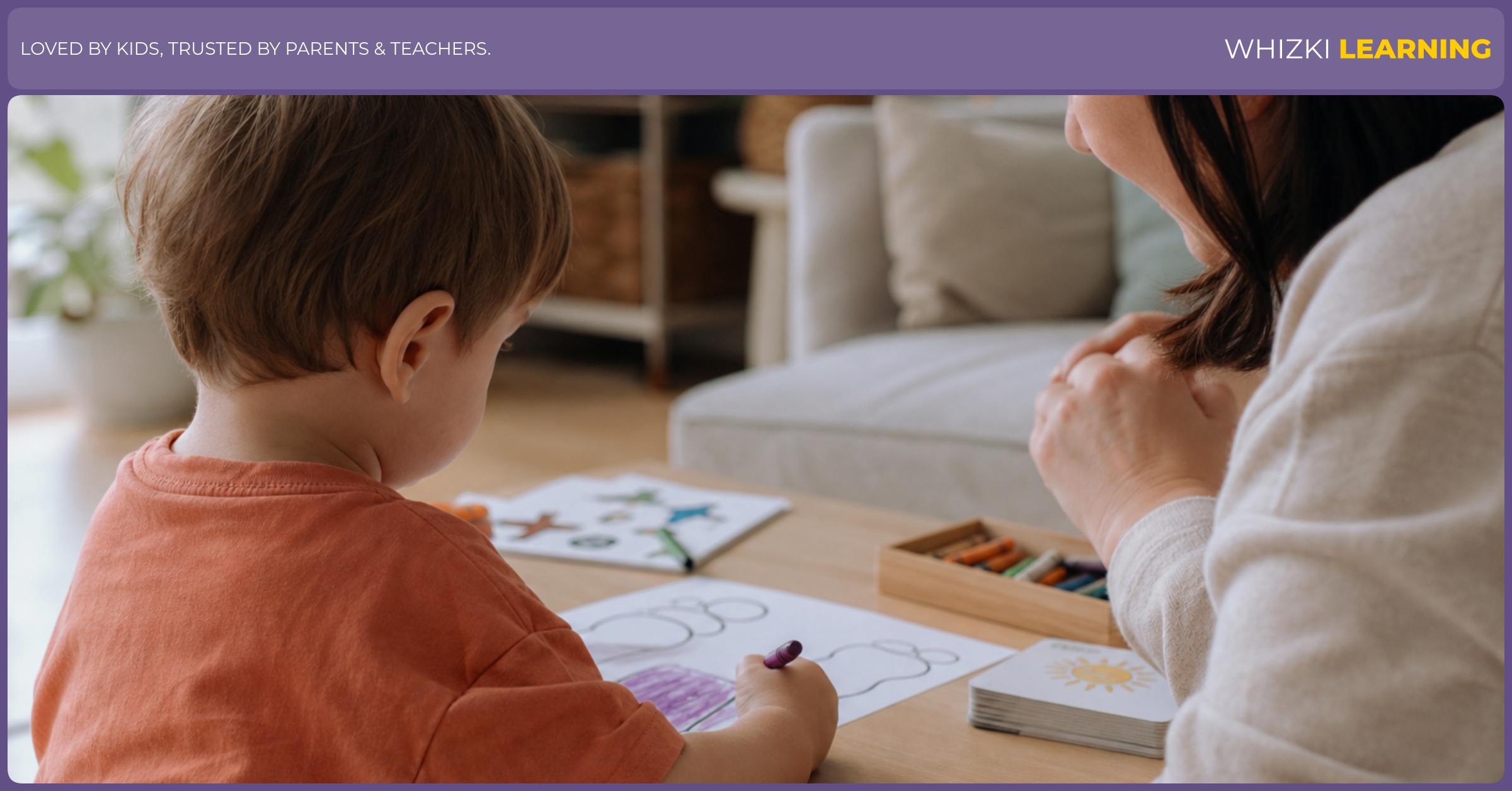 A young child uses a chunky crayon on a simple worksheet while an adult watches nearby.