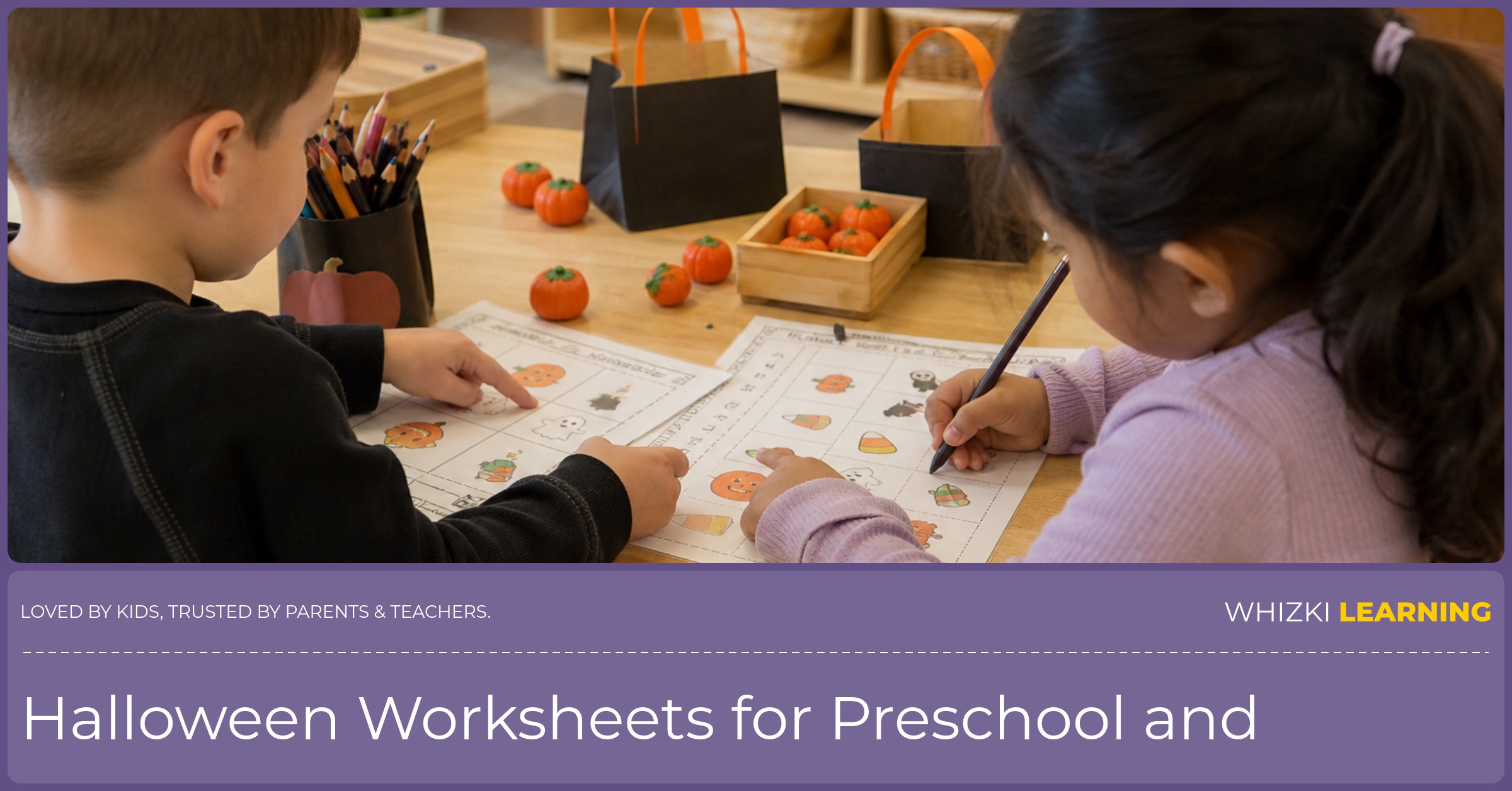 Two kindergarten children work quietly at a classroom center with Halloween worksheets, pencils, crayons, and small seasonal objects.