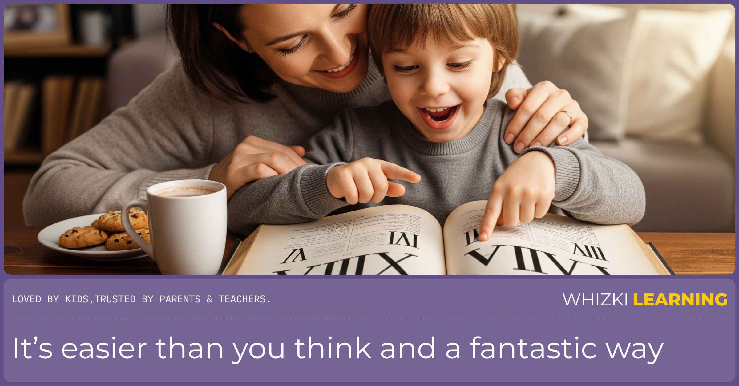A mother and her young son are sitting on a couch, looking at a book together. The boy is pointing at a page with a curious and excited expression.