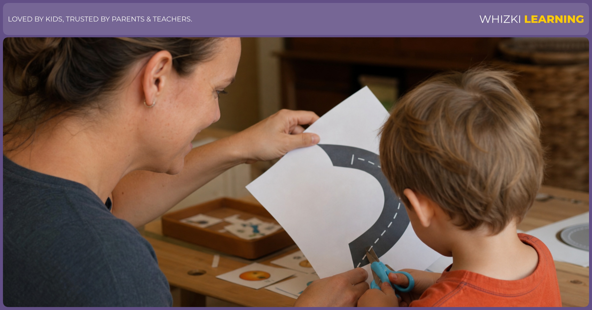 A caregiver and young child work together on a curved cutting worksheet in a warm home setting.