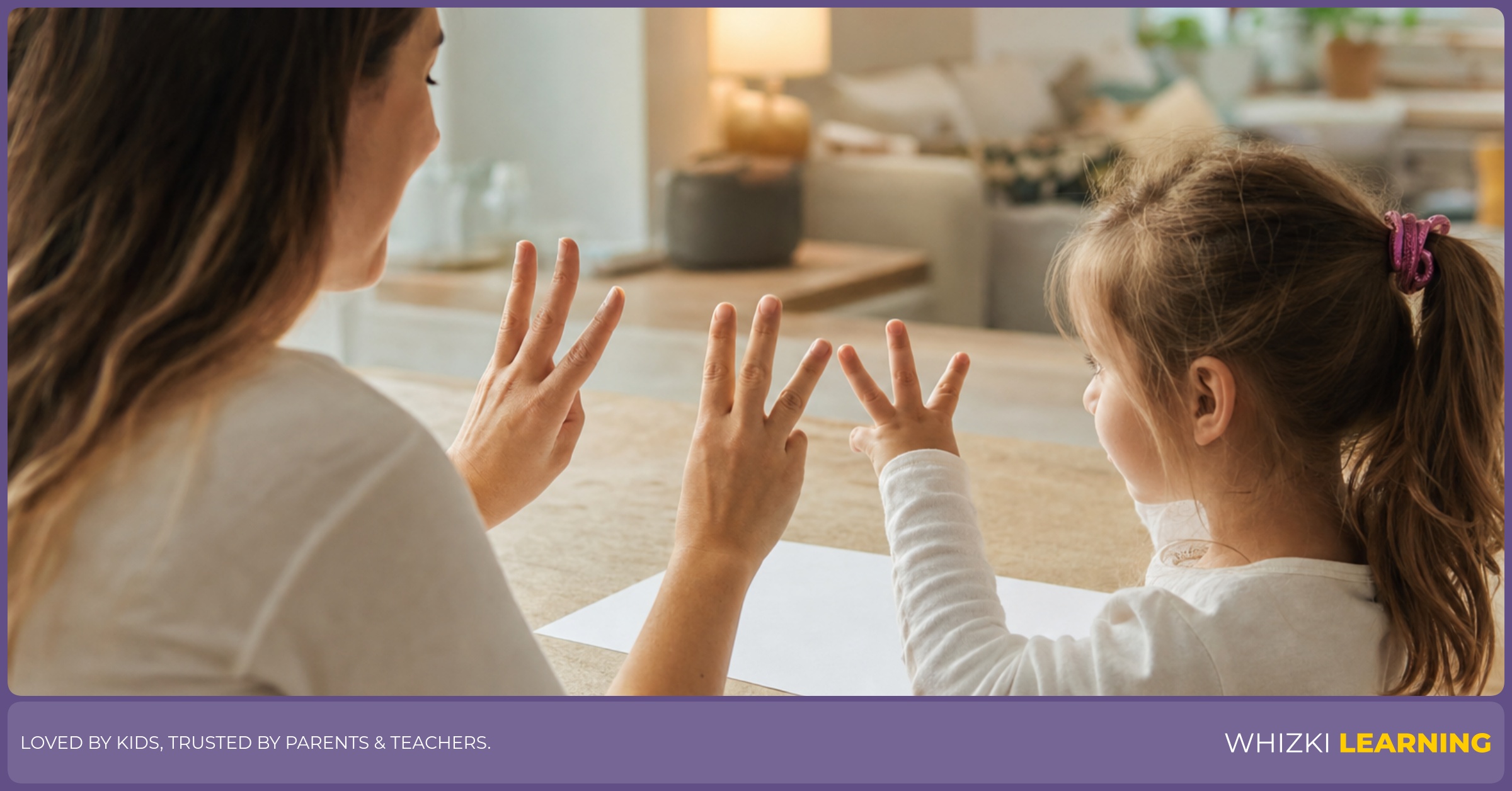 A caregiver helps a child show three fingers across two hands during a finger-bond game.