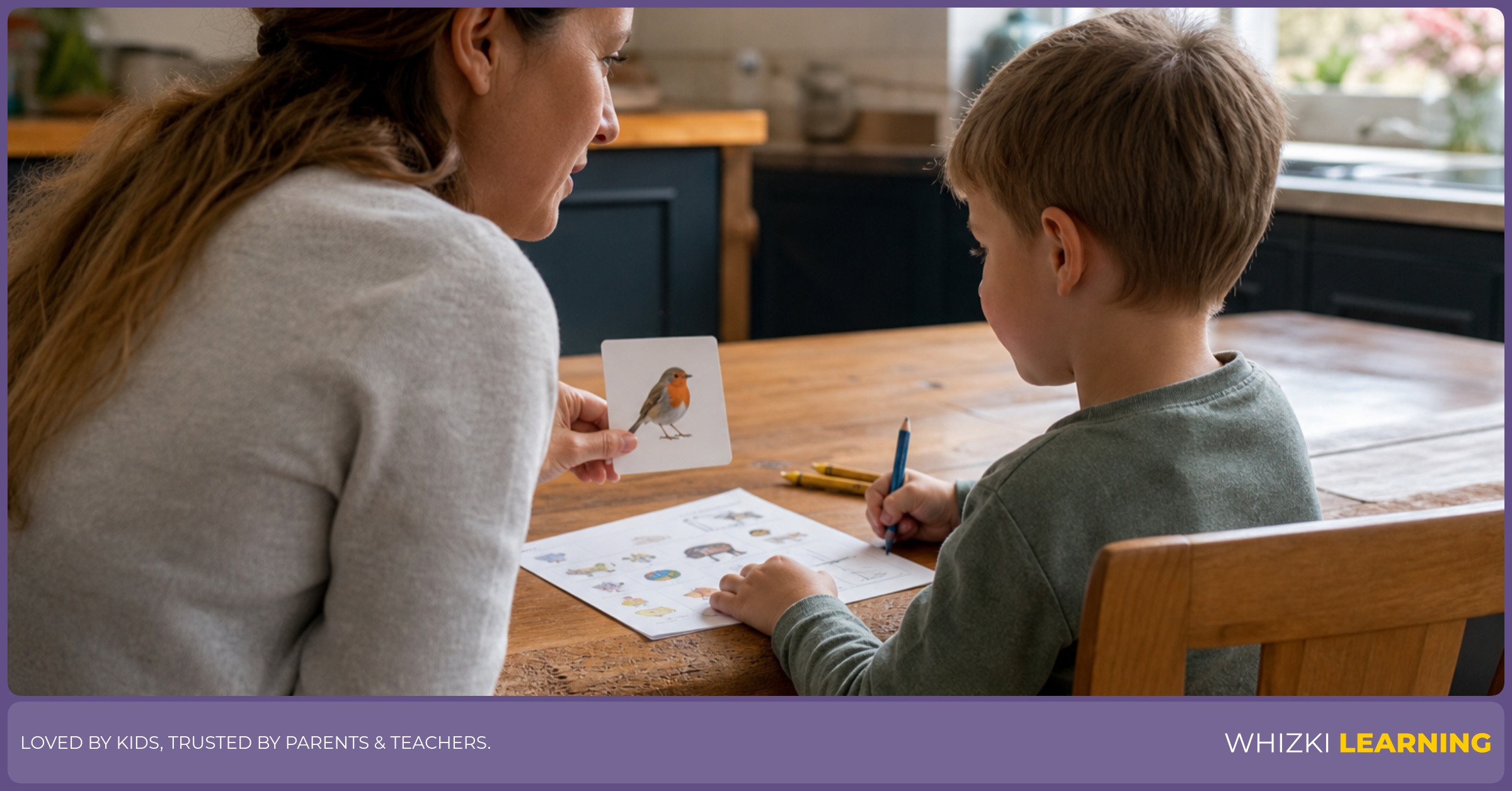 A parent sits beside a five-year-old doing a short pencil-and-paper activity at a warm kitchen table.