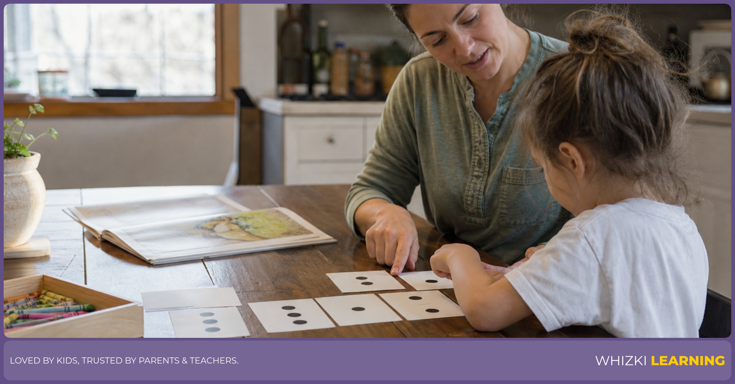 A parent and child arrange paper cards and crayons on a kitchen table while planning a flexible homeschool rhythm.