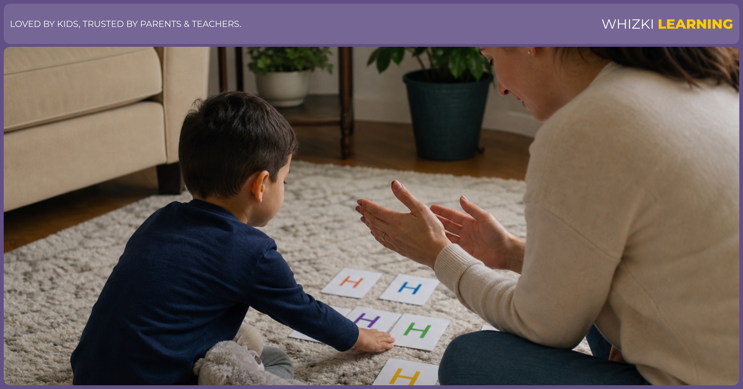 A parent sits beside a young child using H action-word cards for a screen-free movement game.