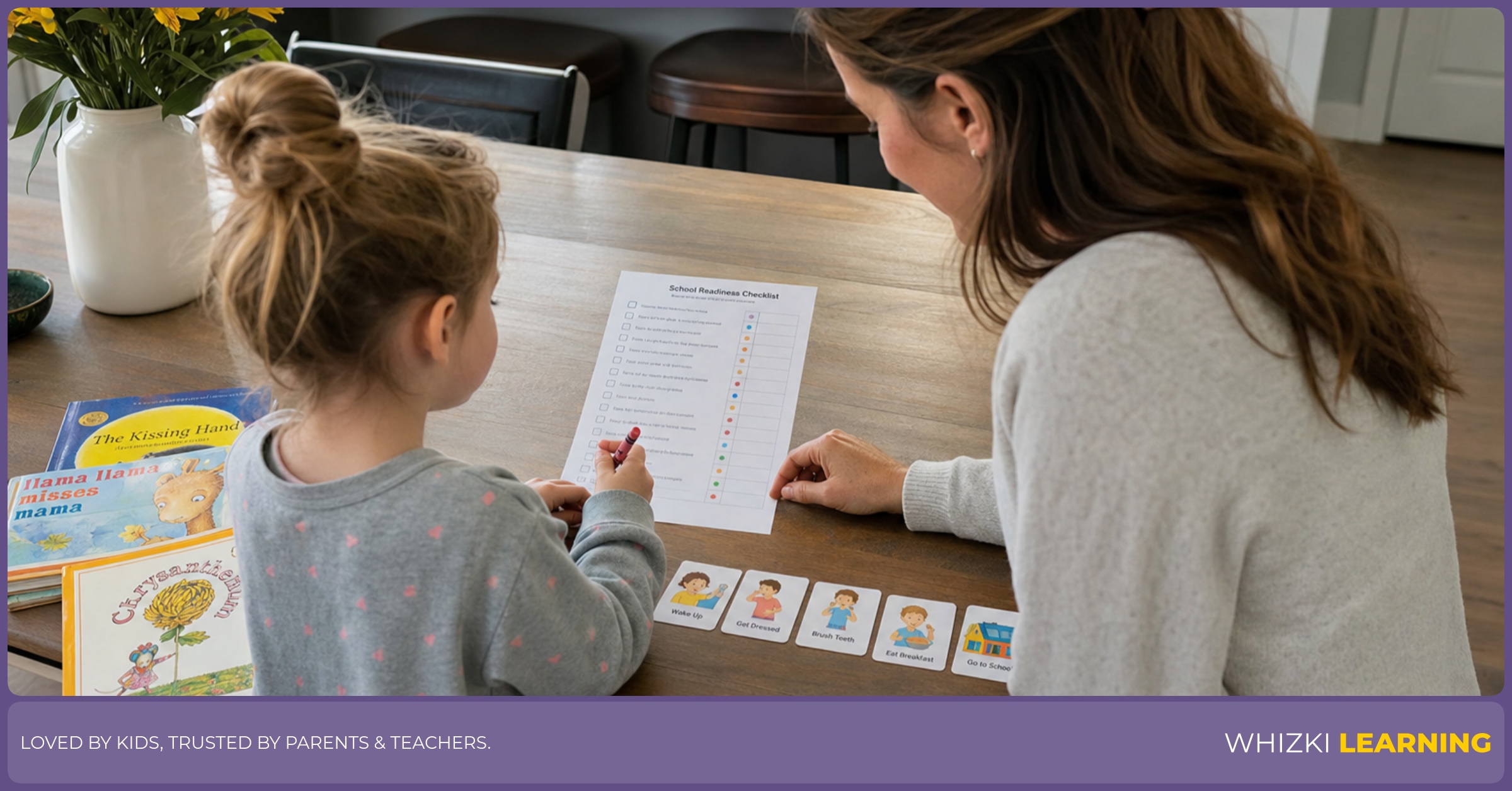 A parent and young child sit at a kitchen table and review a kindergarten readiness checklist with crayons and books nearby.