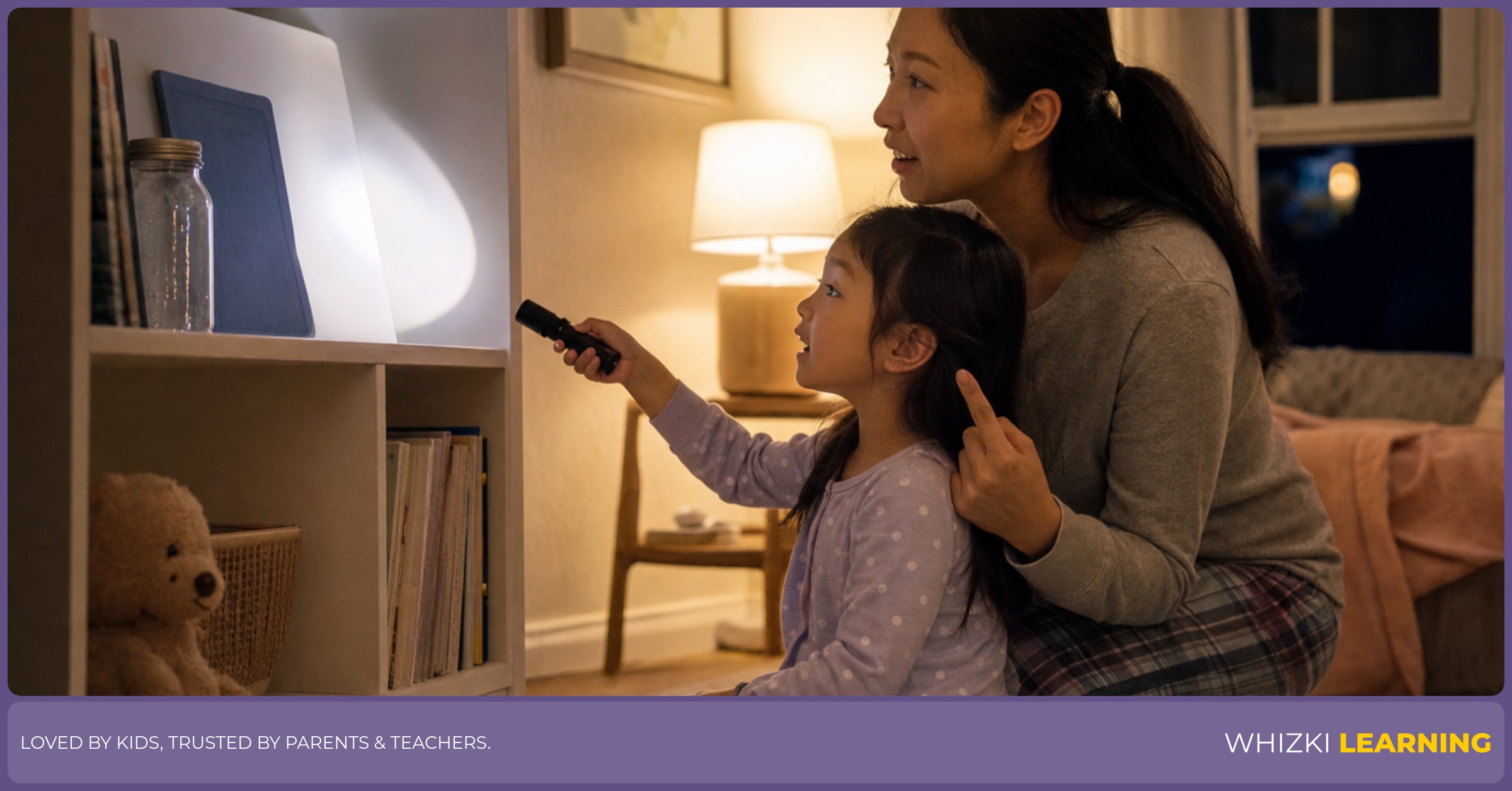 A parent and child use a small flashlight to point at items and practice J words before bedtime