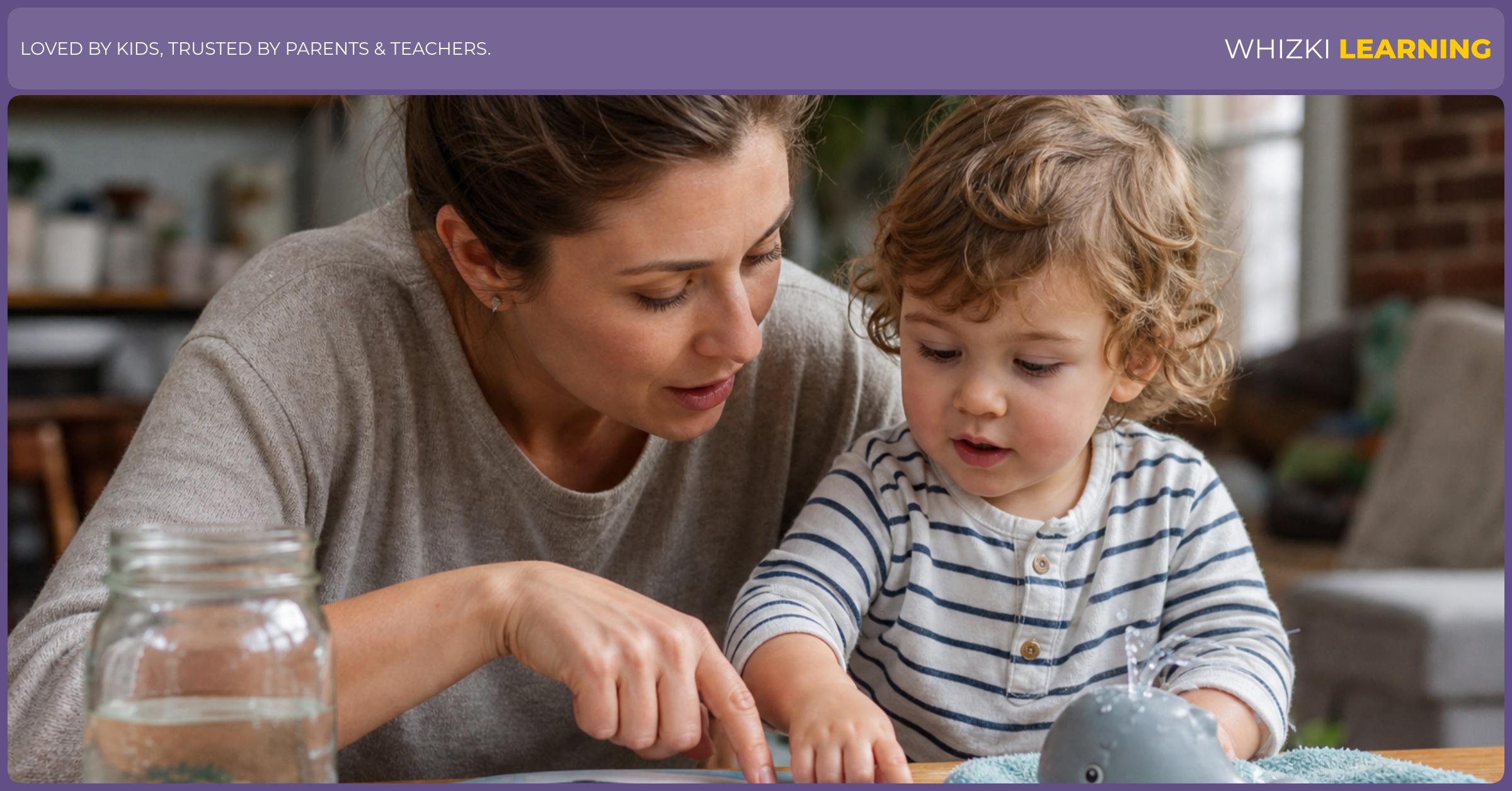 A parent and child sit at a kitchen table with a jar, book, and bath toy, pointing and practicing J words together