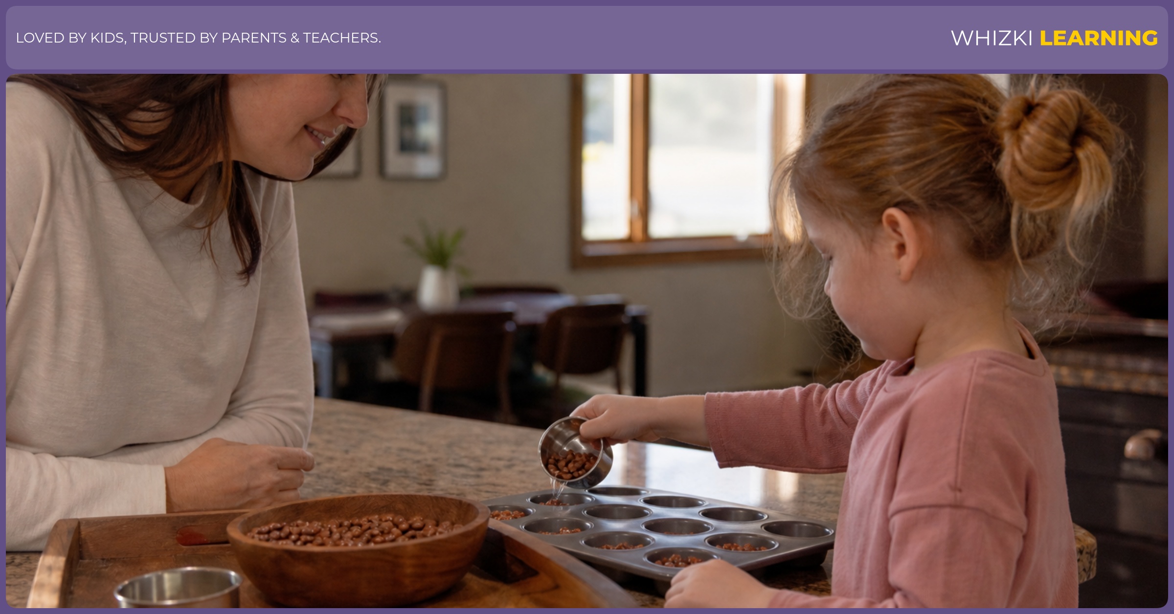 A parent watches a young child pour beans between small cups on a tray at the kitchen counter.