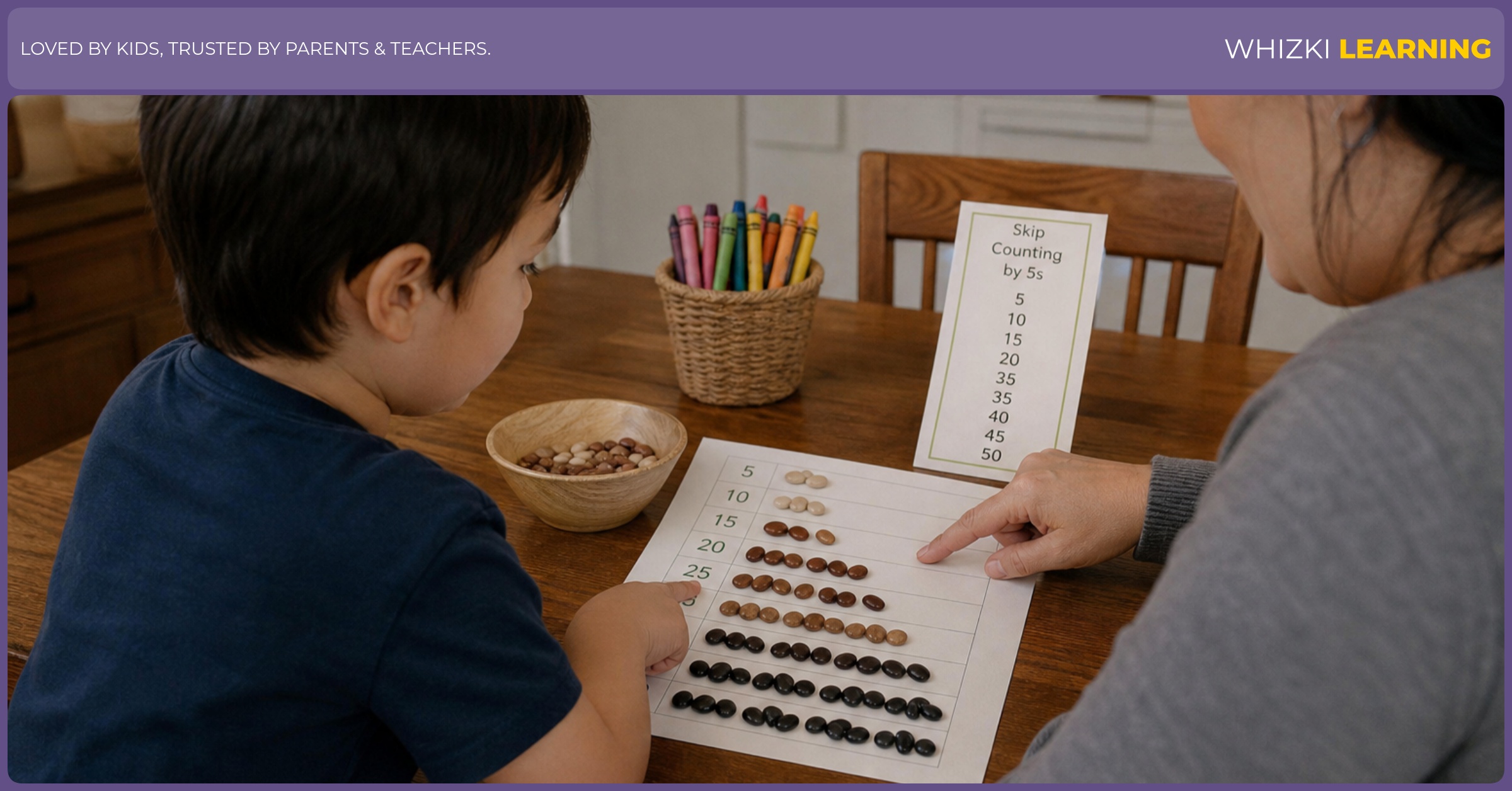 A parent sits beside a child who is touching bean piles while marking a skip counting by 5s chart.