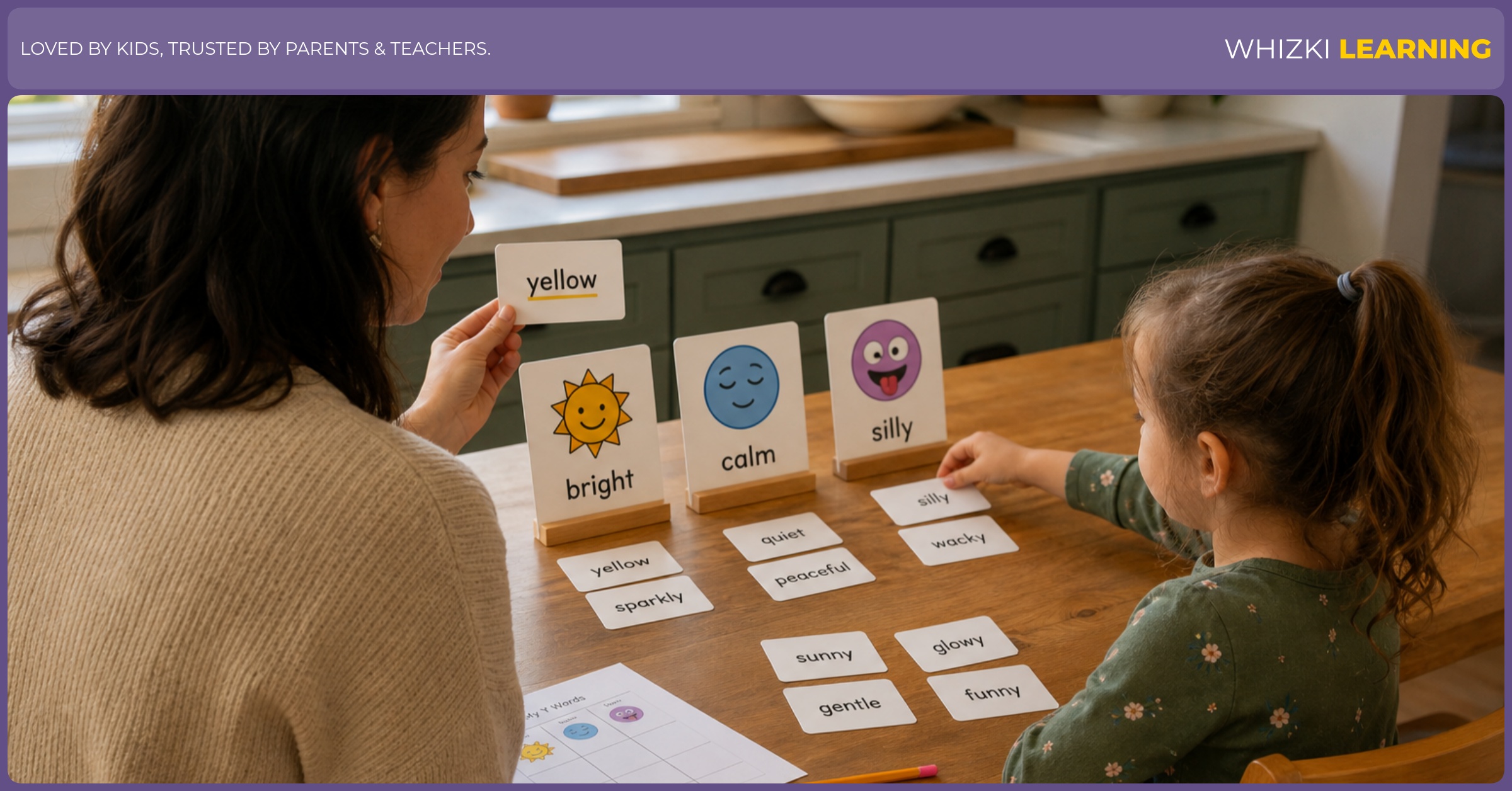 A parent and child sort Y adjective cards into three piles at the kitchen table, pointing with their fingers and smiling calmly, with warm natural light