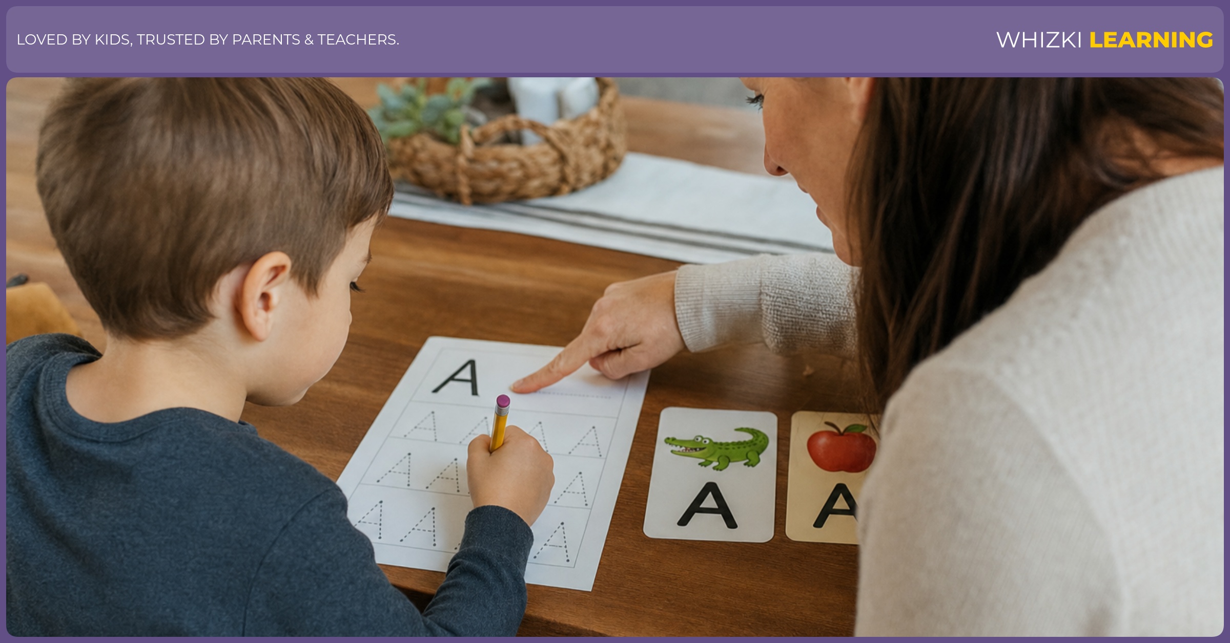 A caregiver gently points to a start spot while a child practices one letter with a pencil on paper.