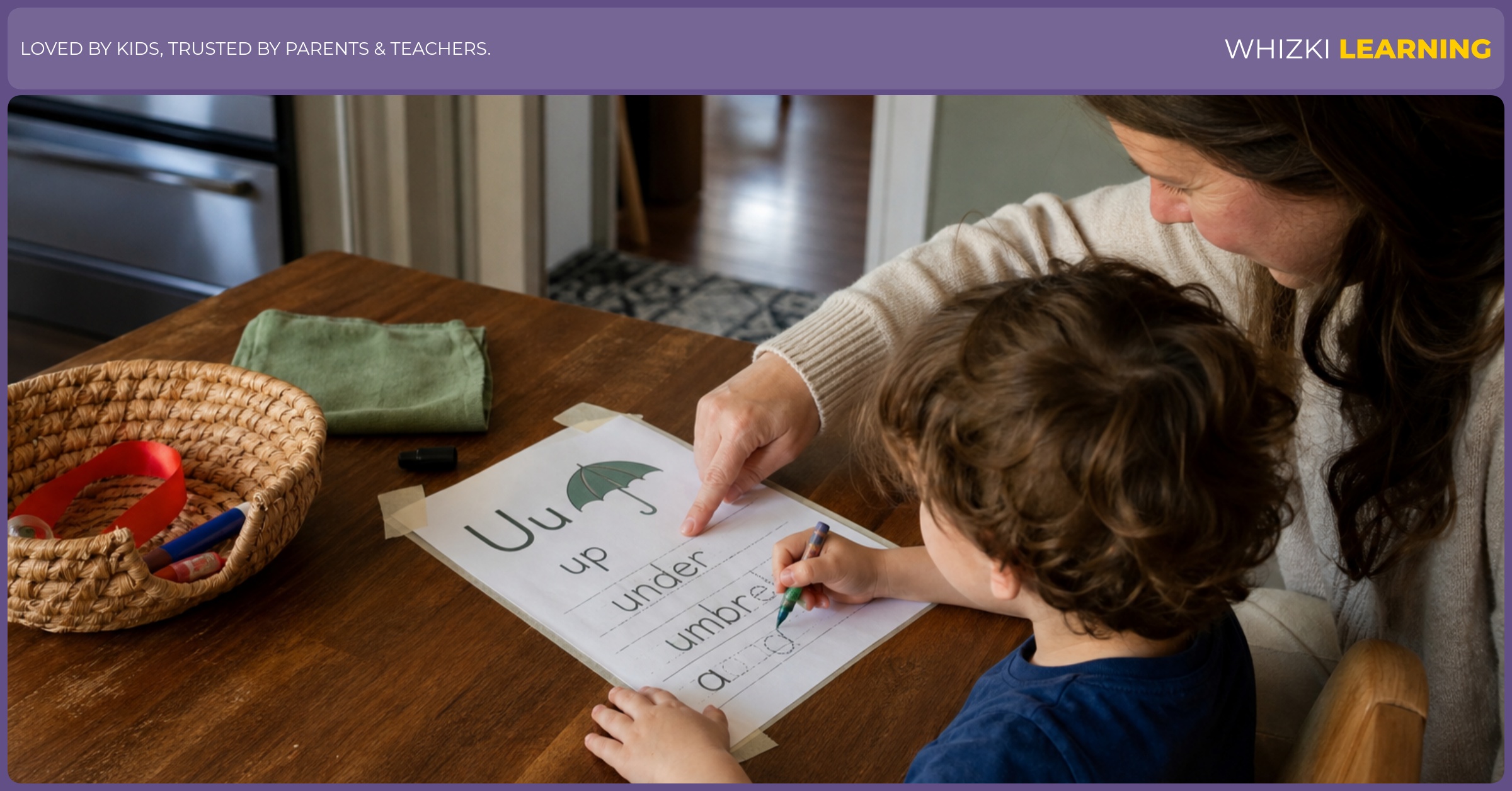 A caregiver and child practice U action words with a taped printable and household objects at a kitchen table.
