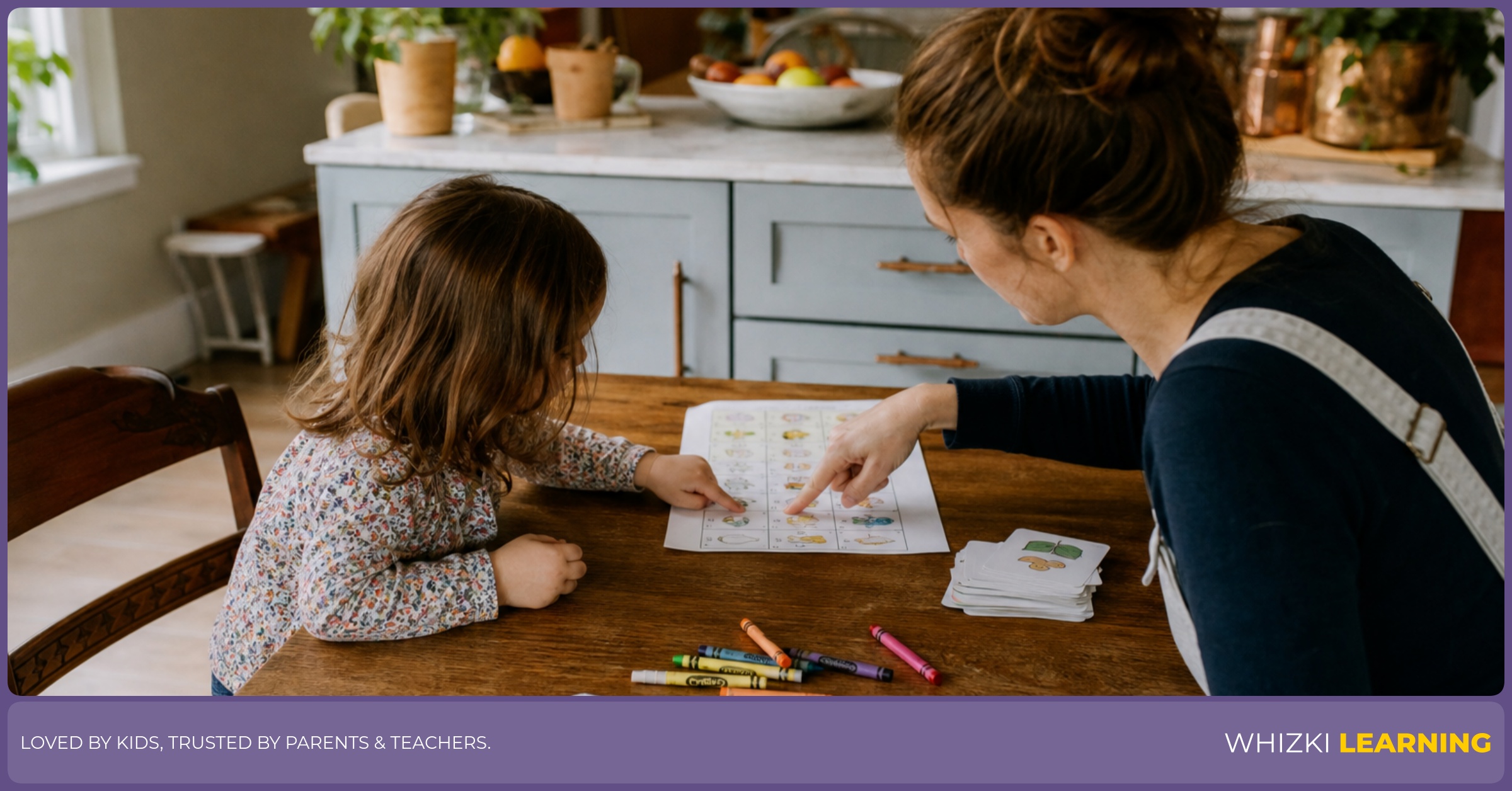 A parent and young child sit at a kitchen table with a weekly learning page, crayons, and a picture book.