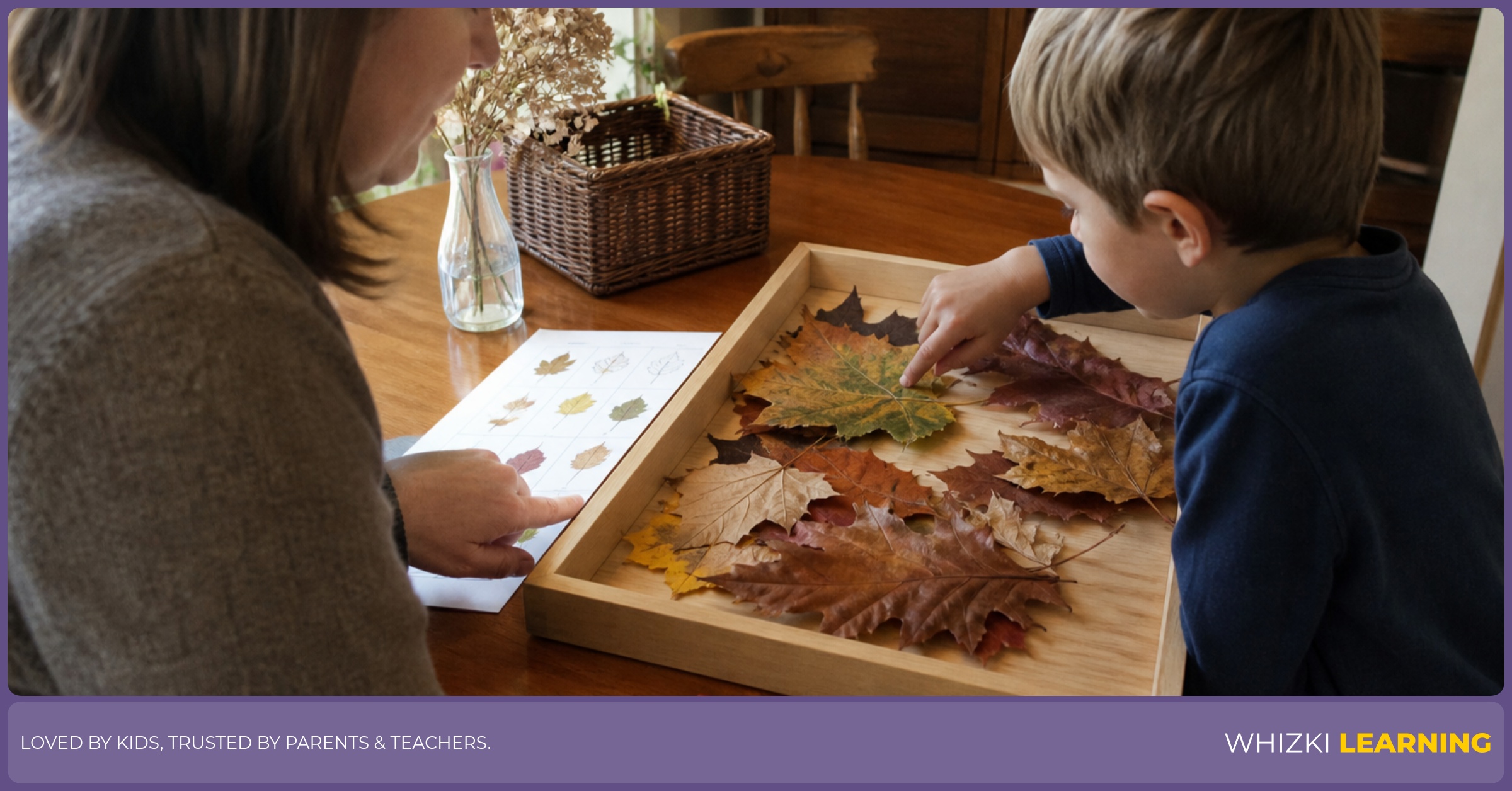 A parent and child sort fall leaves on a kitchen table using a tray, paper, and crayons.