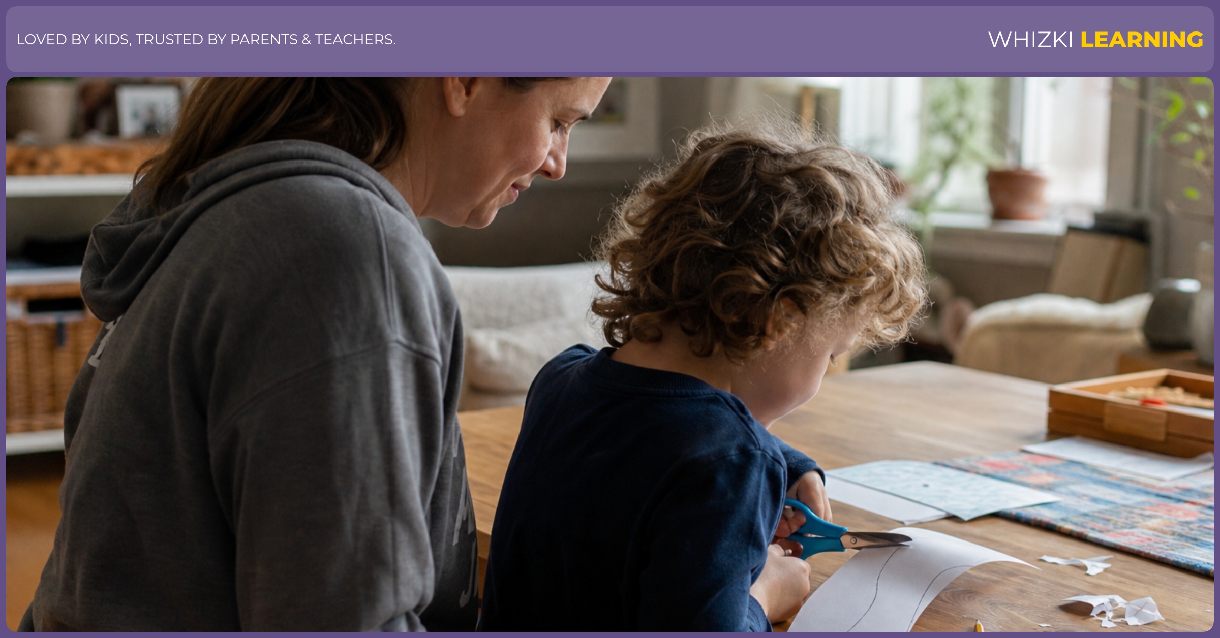 A caregiver supports a left-handed child using child-sized scissors to cut along a simple paper path.
