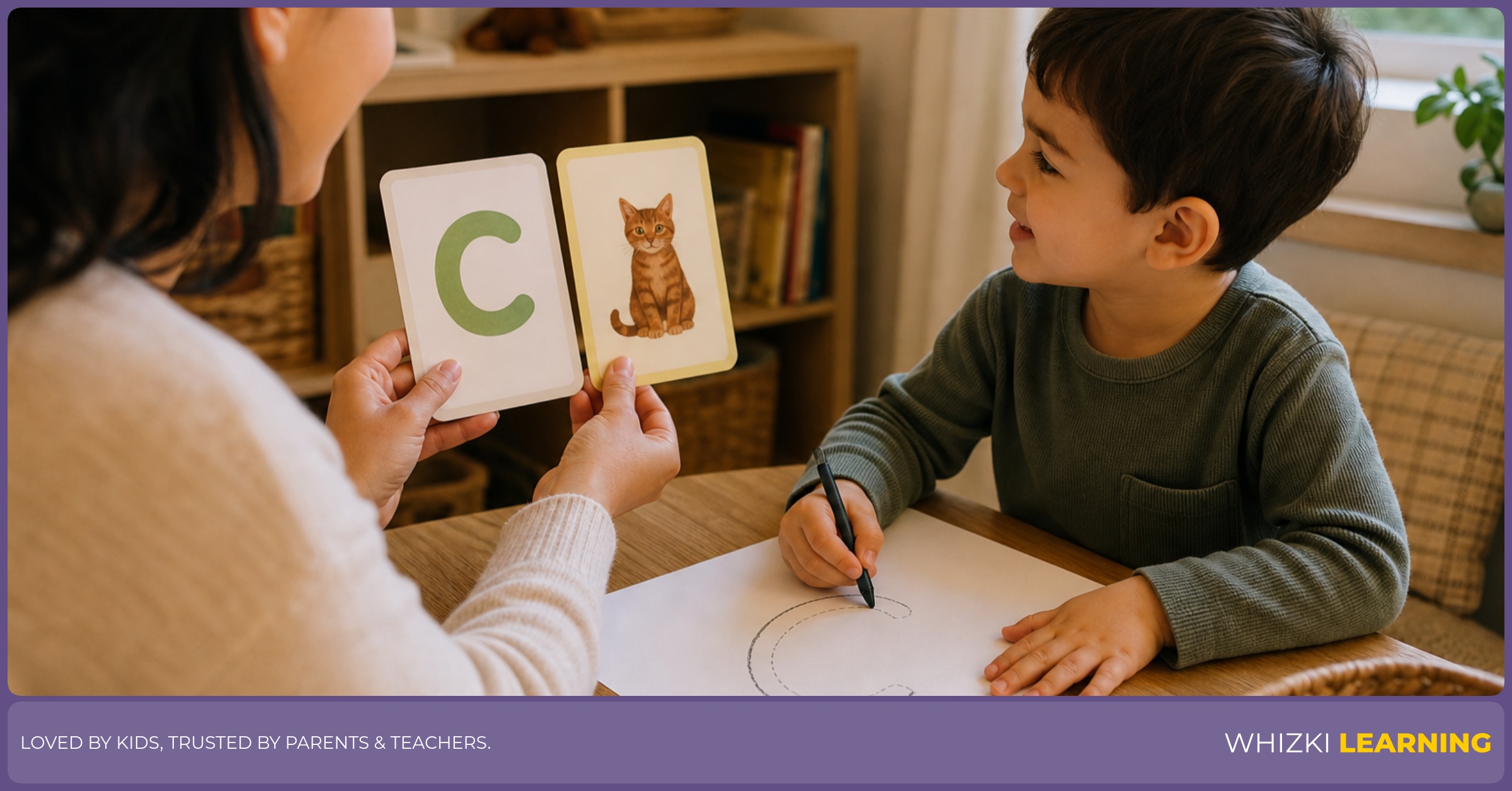 Parent holding letter C and C adjective cards toward the child while the child traces the letter C on paper