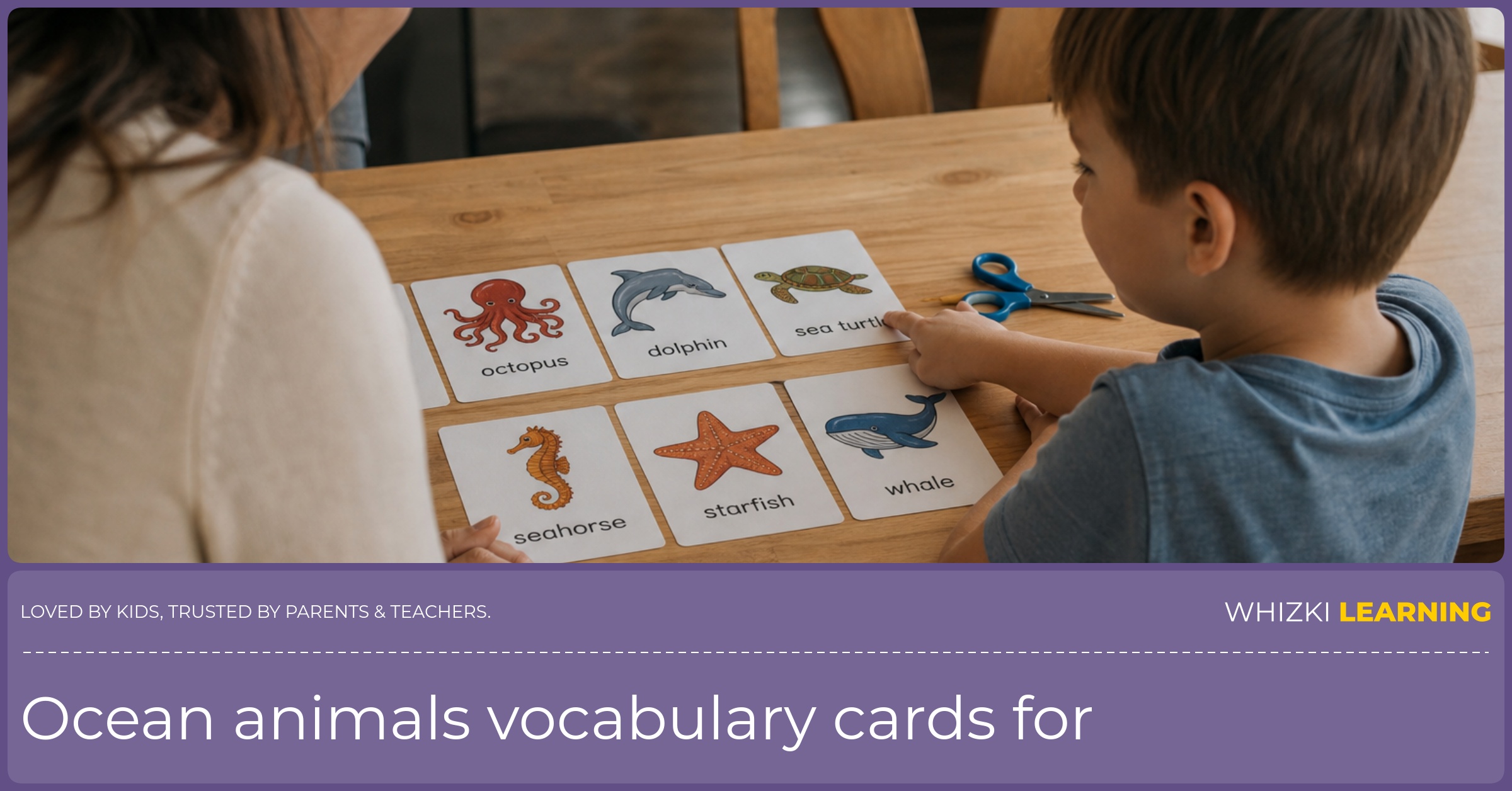 A parent and child sit at a kitchen table naming ocean animal vocabulary cards together.
