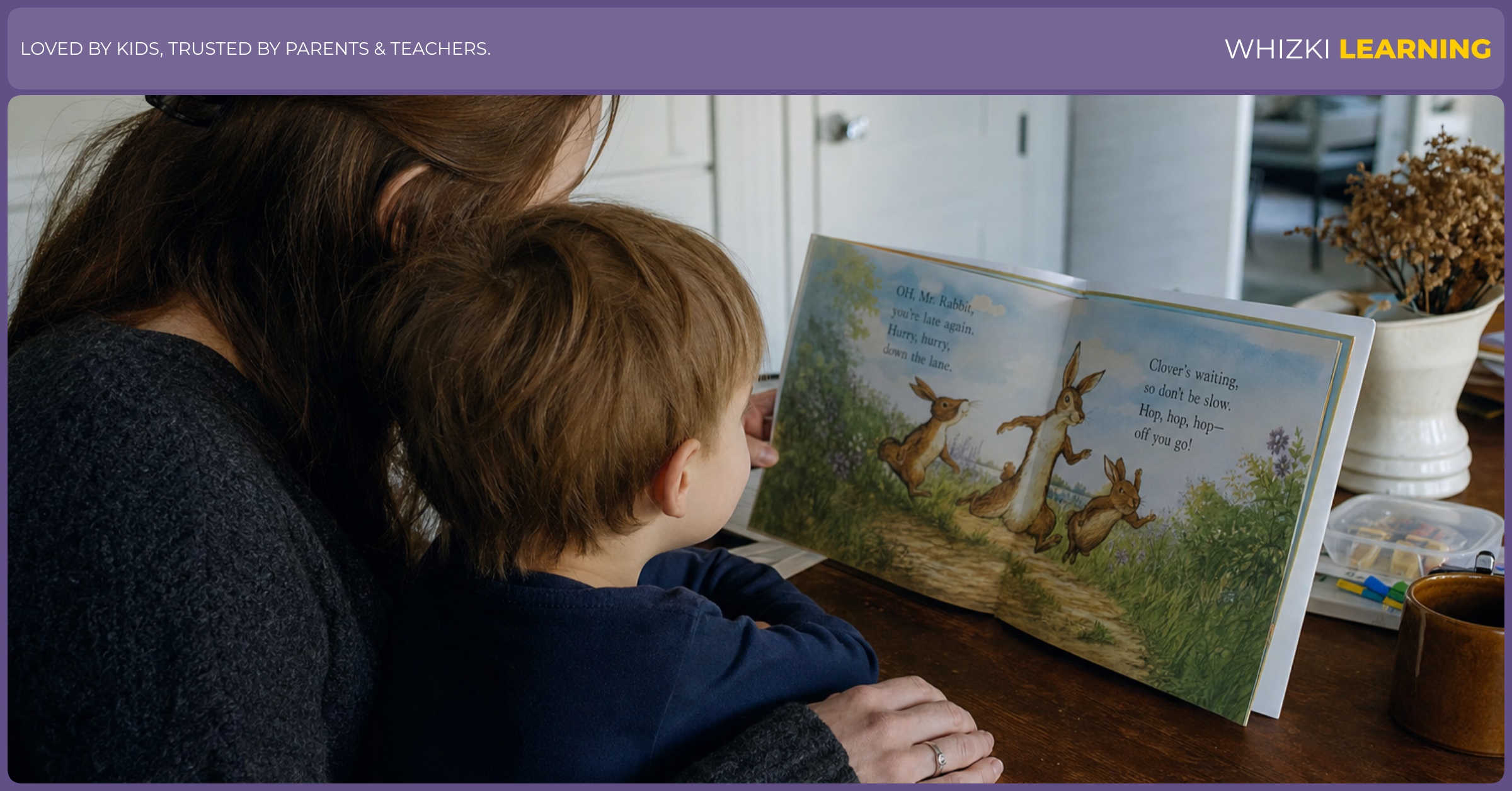A parent and young child read a rhyming picture book together at a kitchen table.
