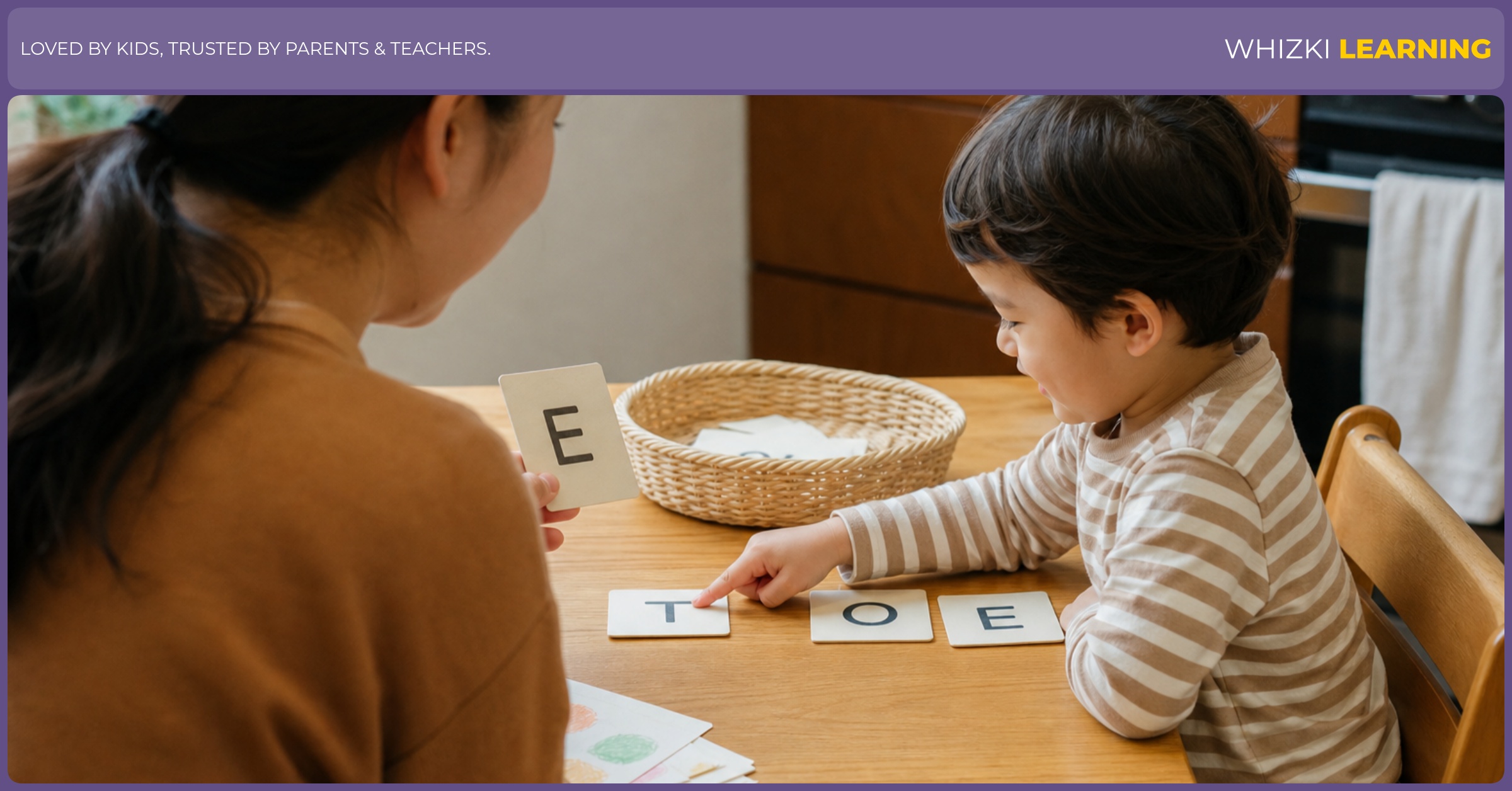 A parent and child sort paper name-letter cards together at a warm kitchen table.