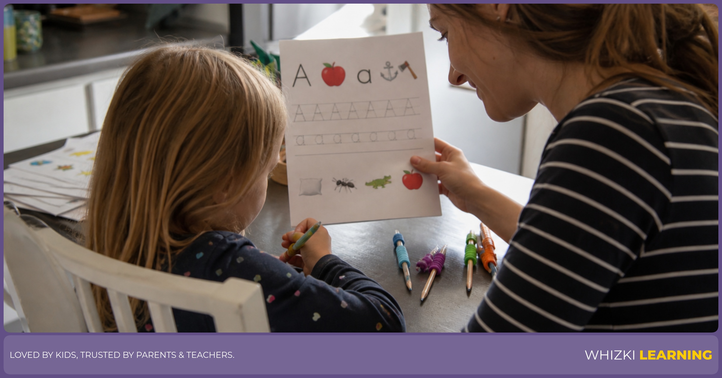 A parent and child sit at a kitchen table checking the margins and contrast on a printed worksheet.