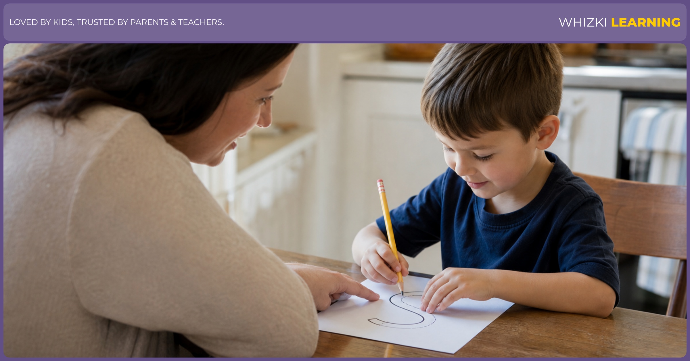 A parent sits beside a 5-year-old at the kitchen table while the child traces one letter on paper with a pencil.