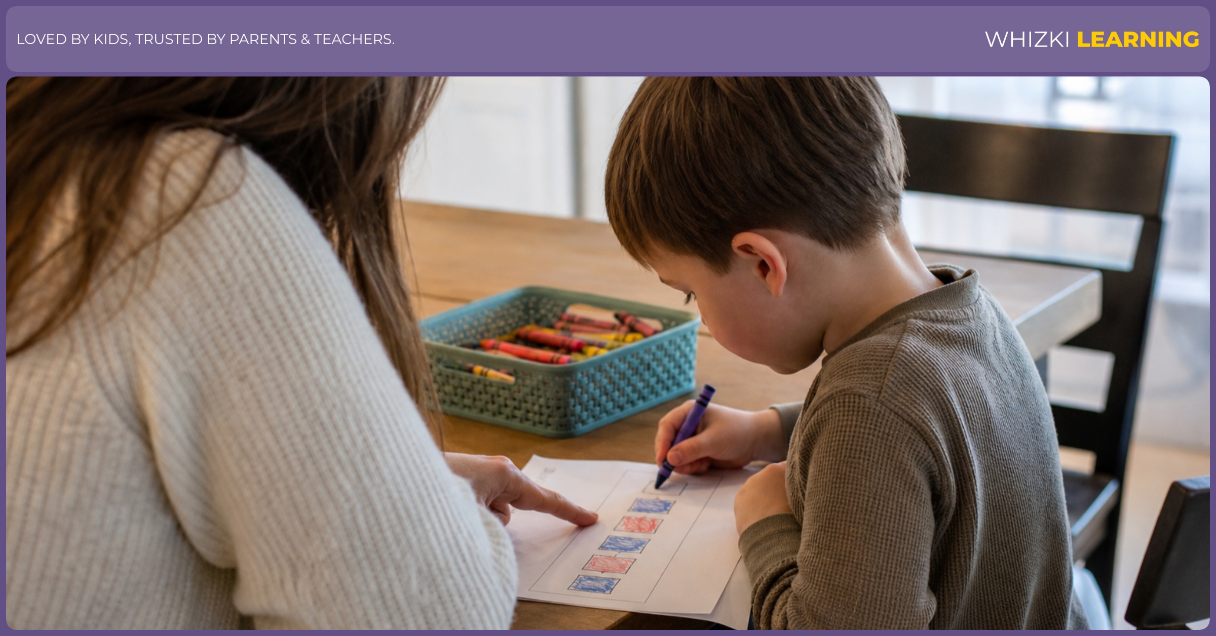 A parent sits beside a preschool child at a kitchen table while the child colors an AB pattern worksheet with crayons.