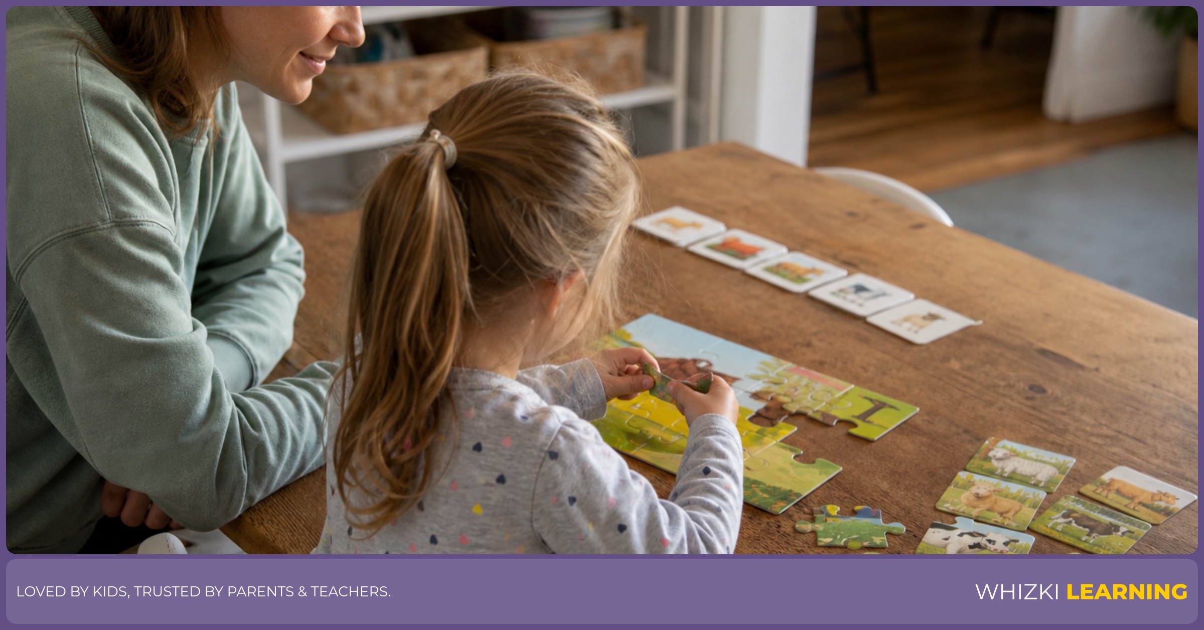 A caregiver sits beside a young child at a kitchen table while the child works on a small puzzle and matching cards.
