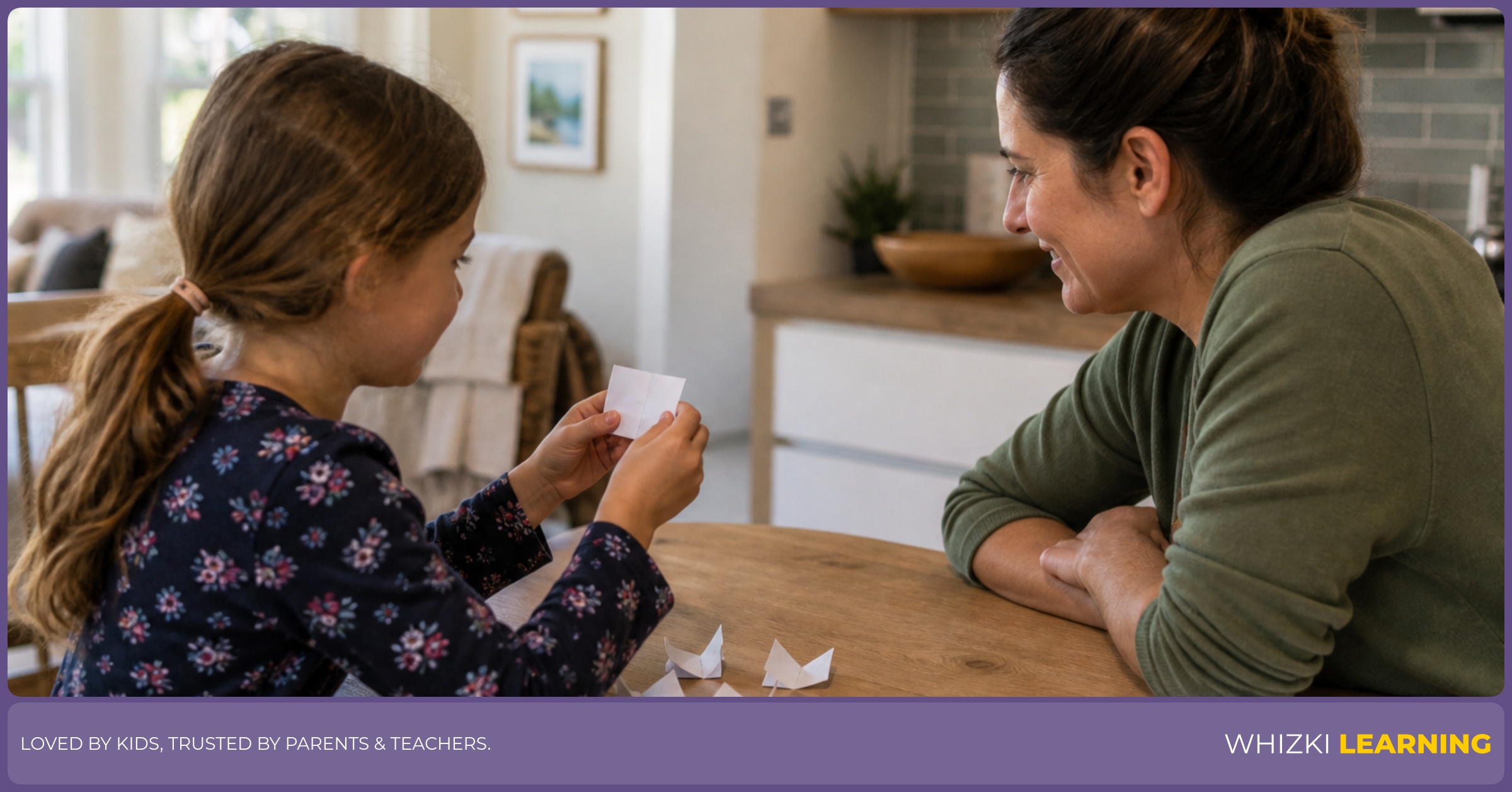 A caregiver and child play R verb charades with folded paper strips at a kitchen table.