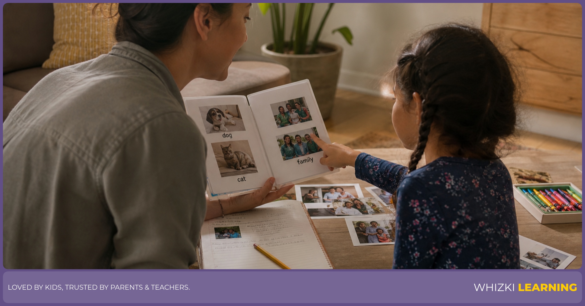 A caregiver and child practice pronunciation with a handmade picture dictionary in a cozy living room.