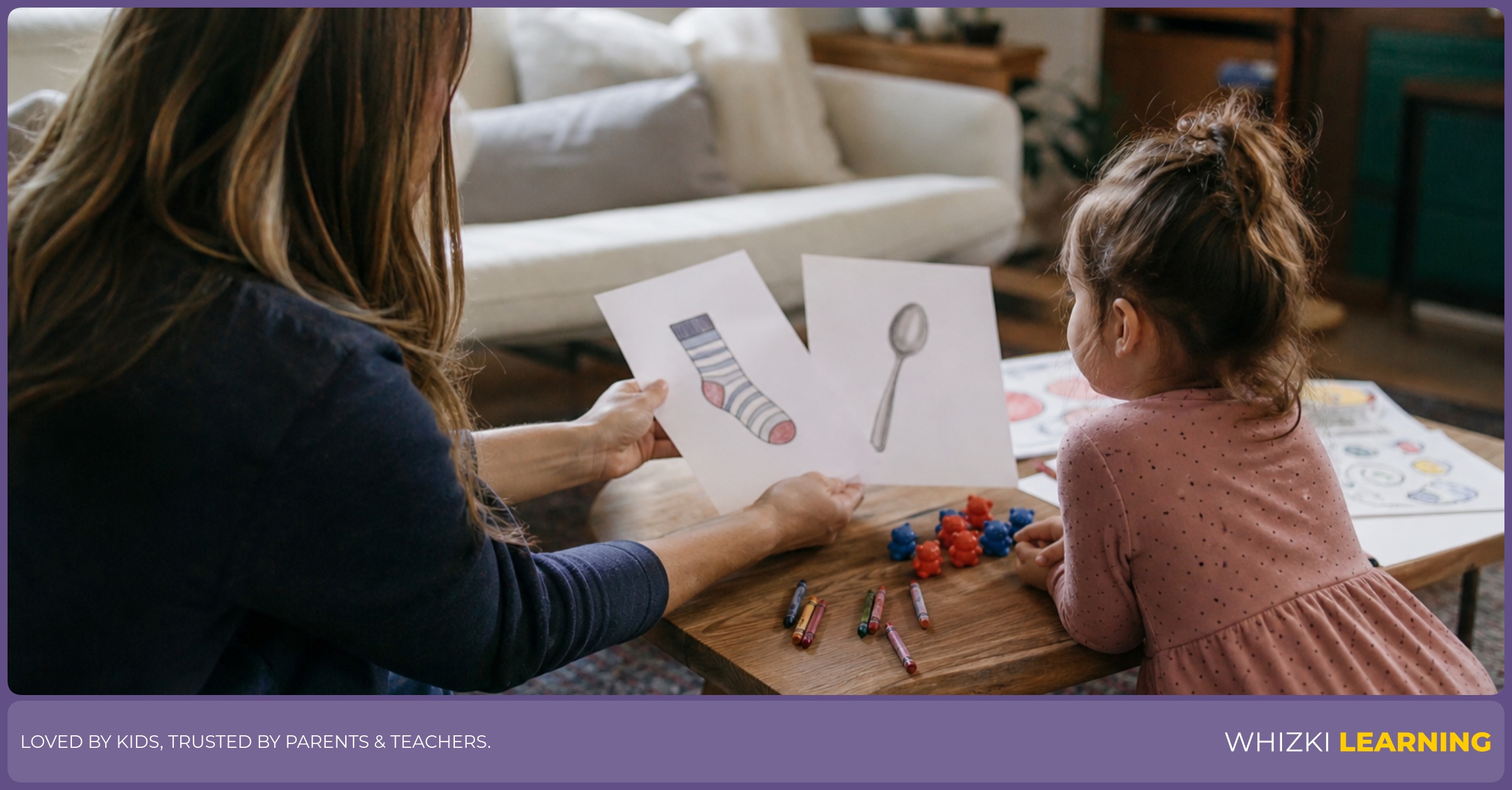 A parent offers two simple printed pages to a young child, with crayons and counting objects spread on a low living room table.