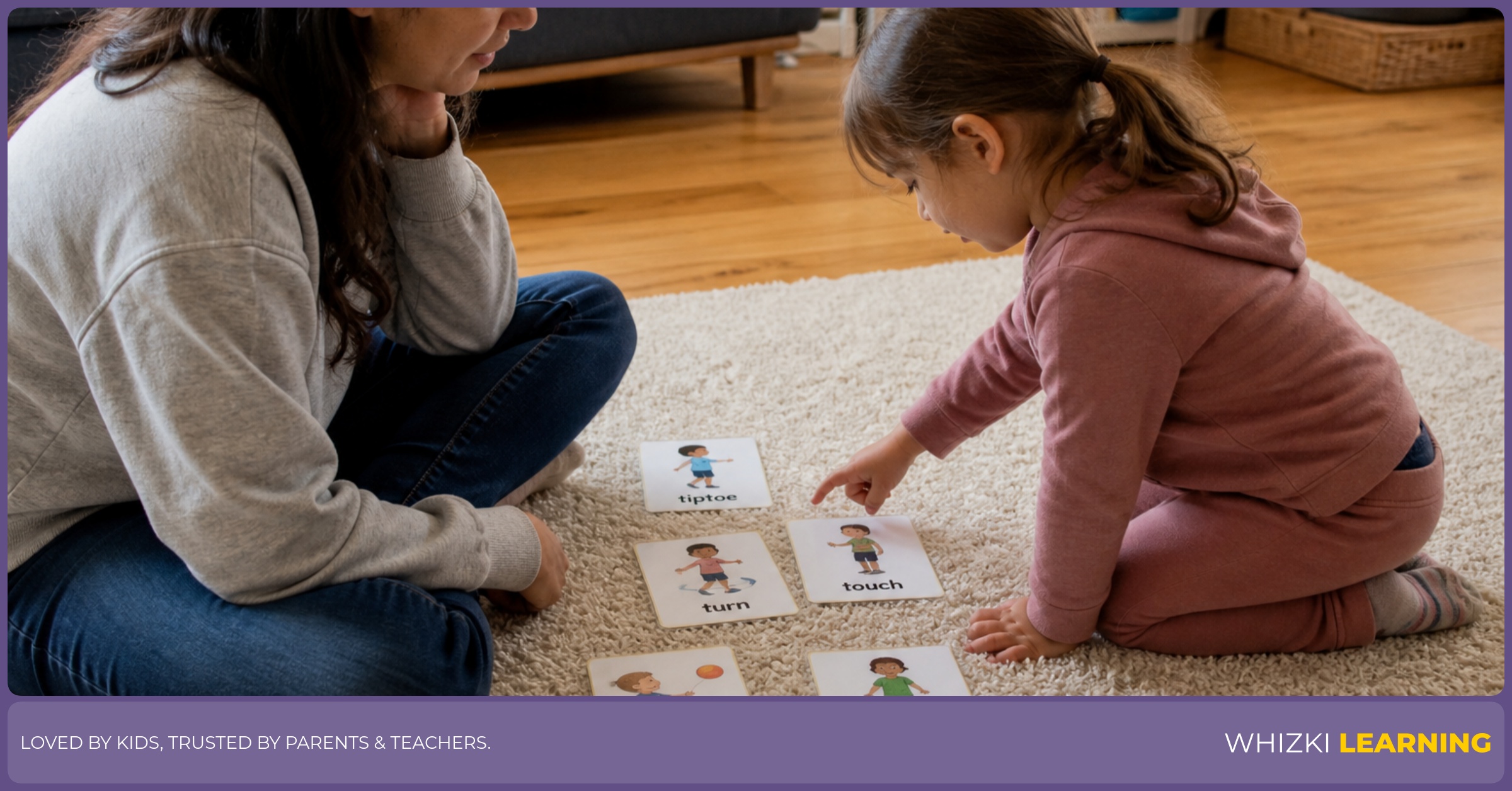 A parent and child practice T action words on a rug while the child taps near a printed card.