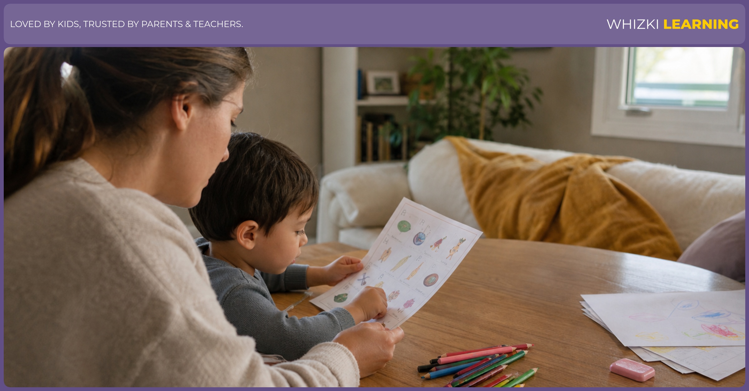 An adult and child review a paper printable together, with crayons and pencils spread on a warm kitchen table.