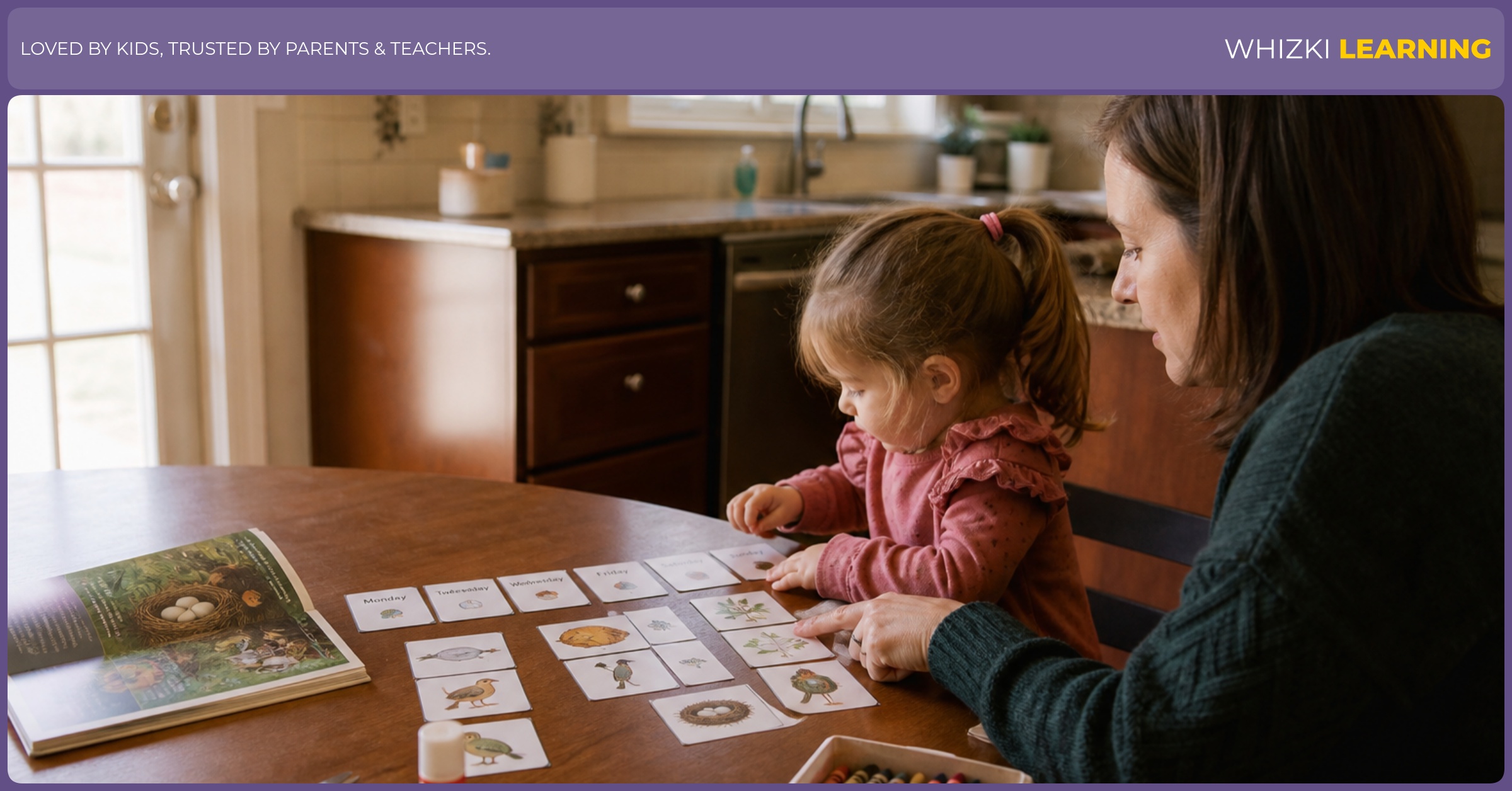 A parent and young child arrange paper activity cards beside a library book and crayons at a kitchen table.