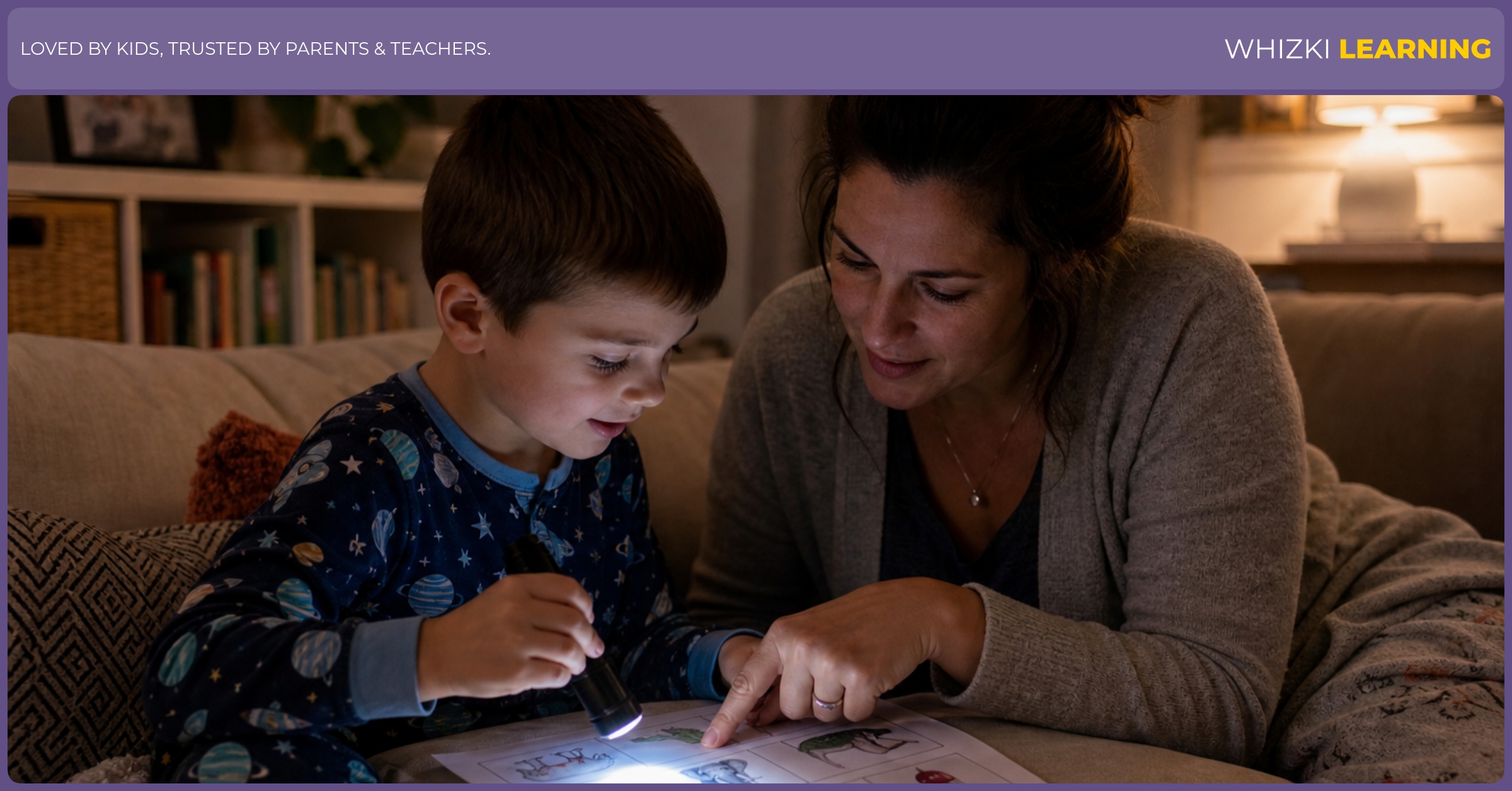 A parent and child use a flashlight to point at E words on paper during a cozy bedtime routine.
