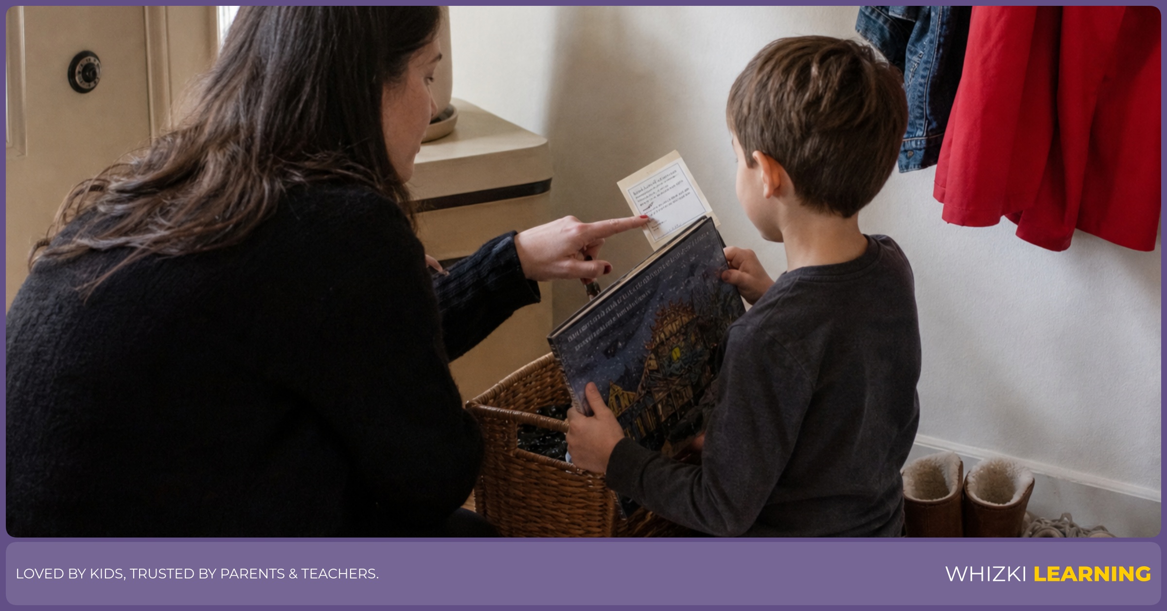 A child places a library book into a small return basket while a caregiver points to the due-date slip.
