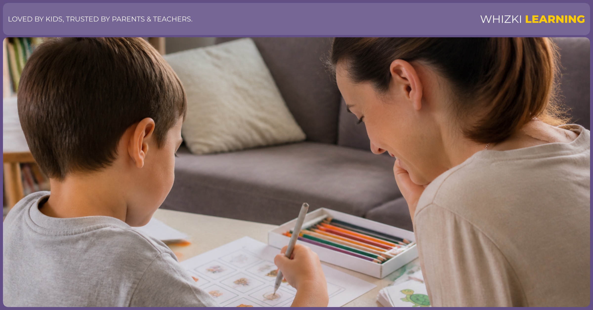 A young child circles a picture answer on a worksheet while an adult watches nearby.