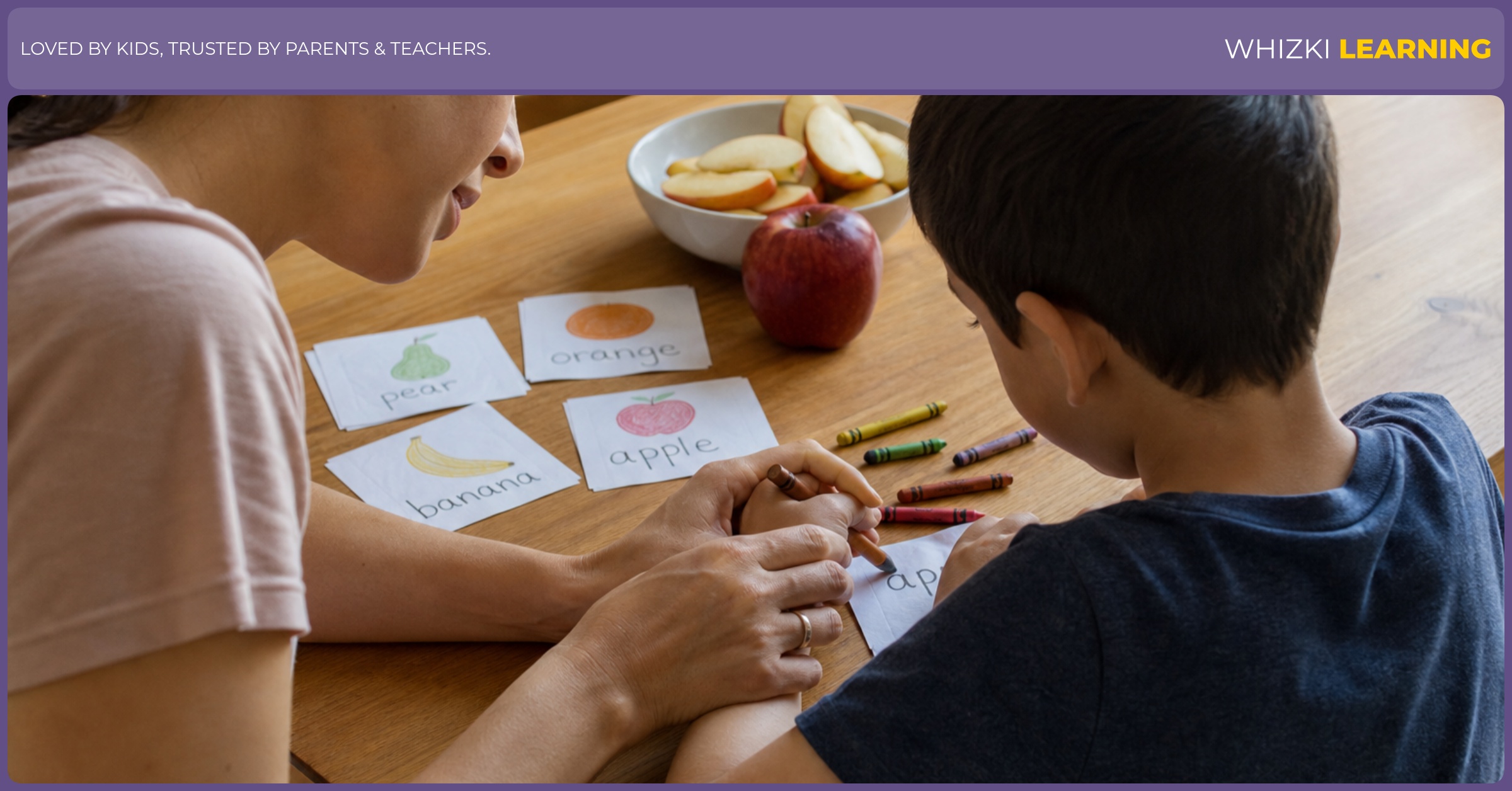 A caregiver and child write food names on small paper slips after playing a rhyming game at the table.