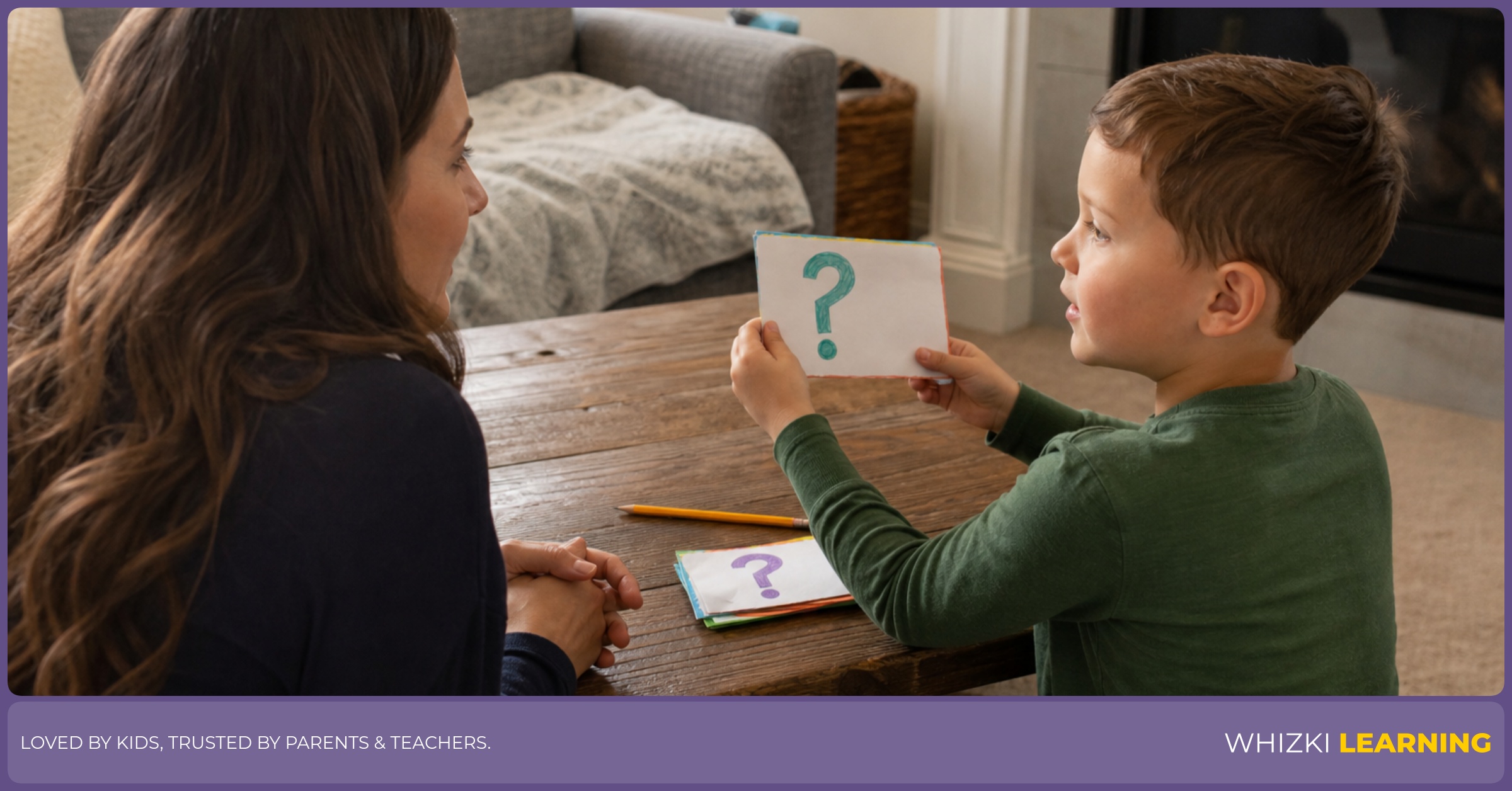 A caregiver and child practice asking one respectful question while holding a handmade paper card in the living room.