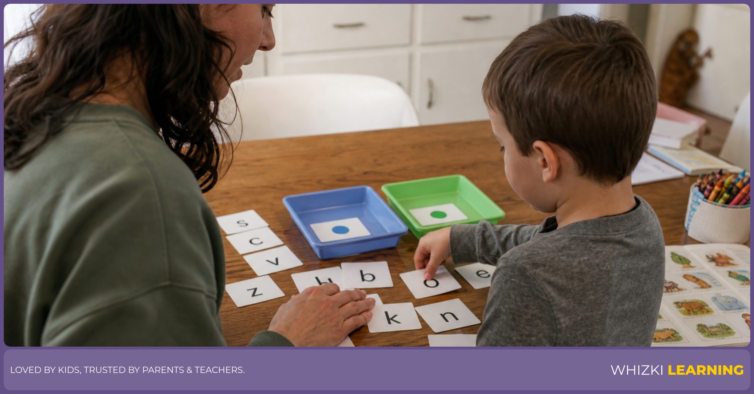 A caregiver and young child sort Ukrainian and Latin letter cards with colored dots at a kitchen table.