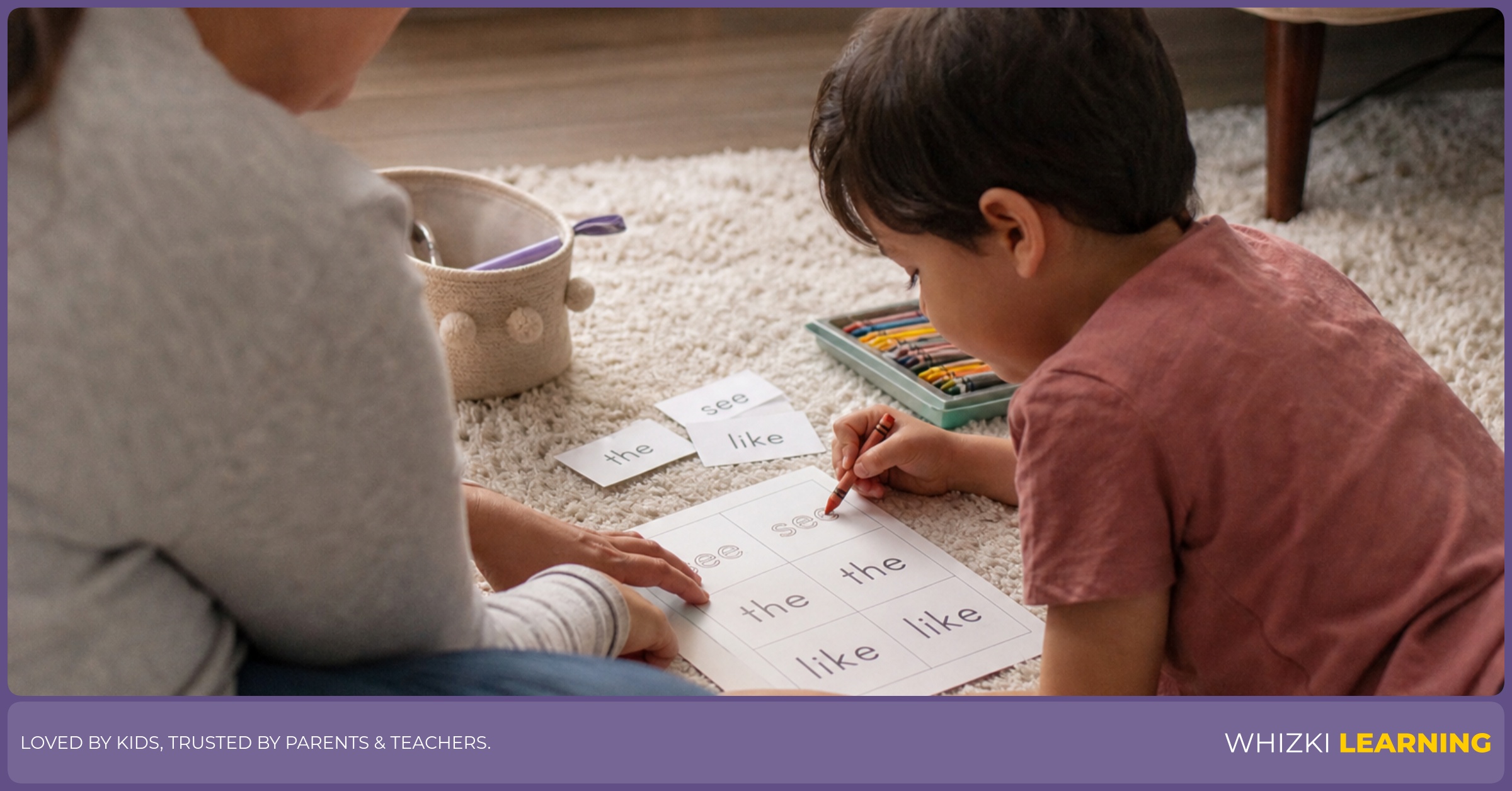 A caregiver helps a child trace a sight word on a printable page in a cozy living room.