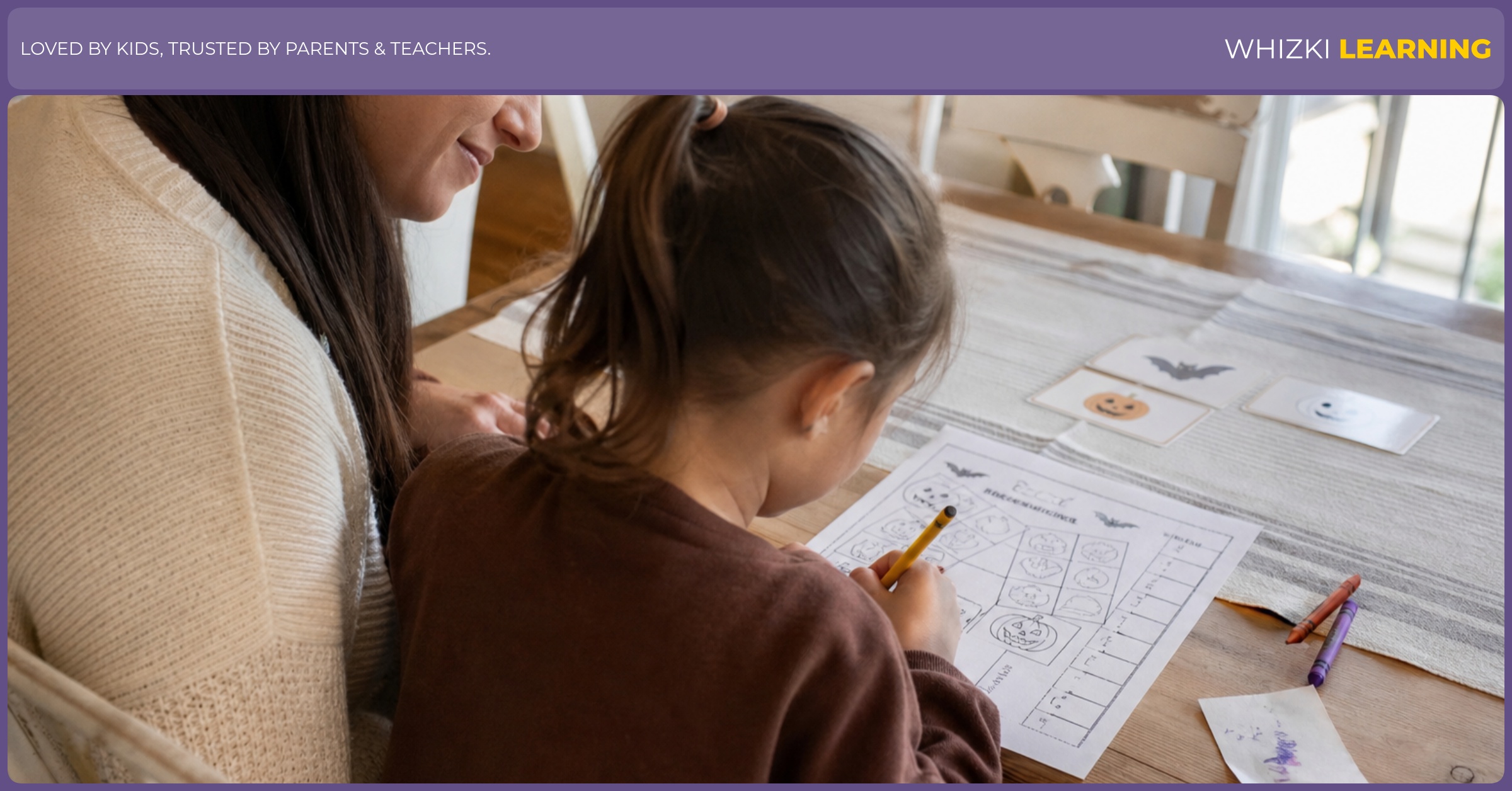 A caregiver supports a child using one printed Halloween activity page with a pencil and crayons in warm kitchen light.